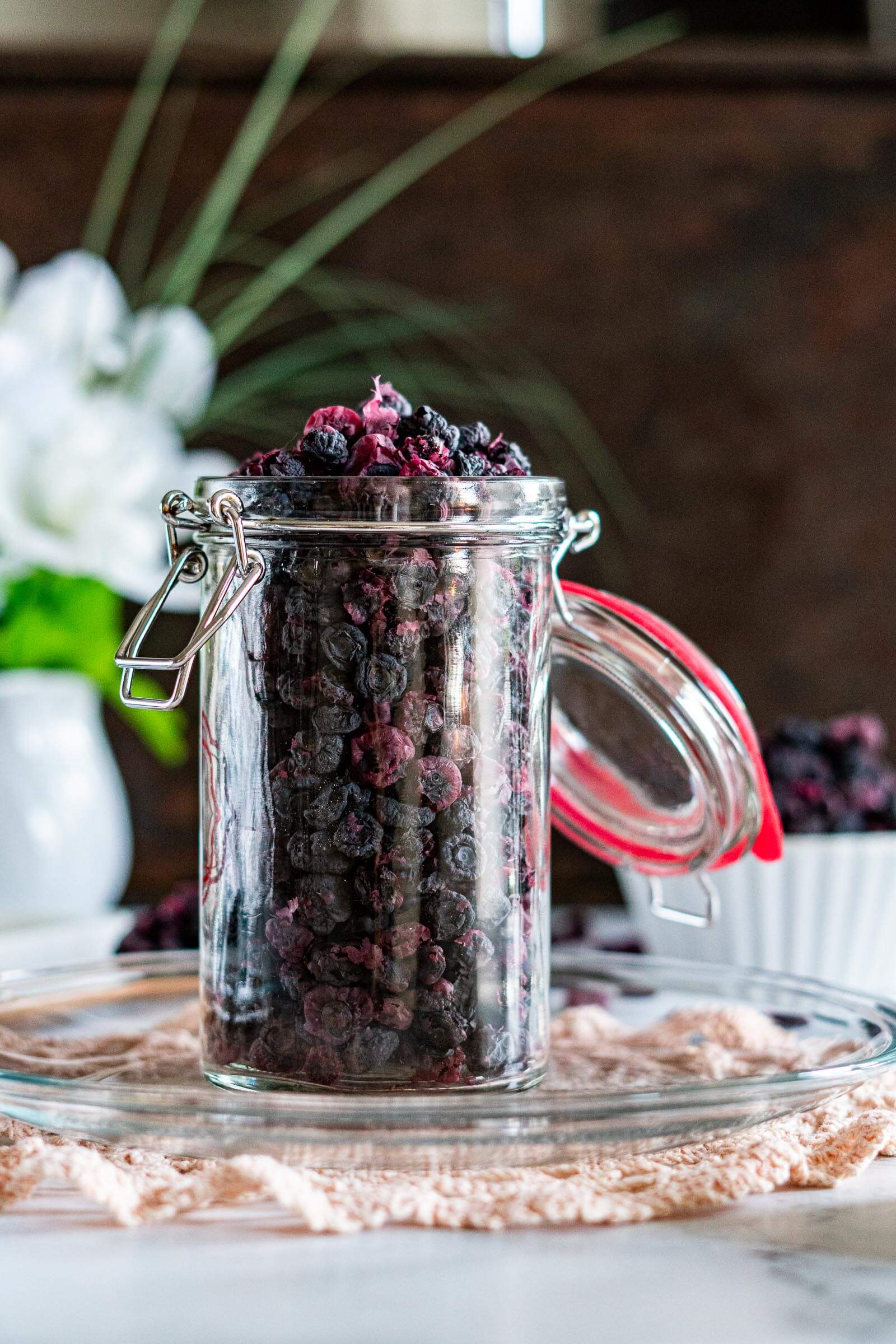 Dried blueberries in a flip top mason jar.