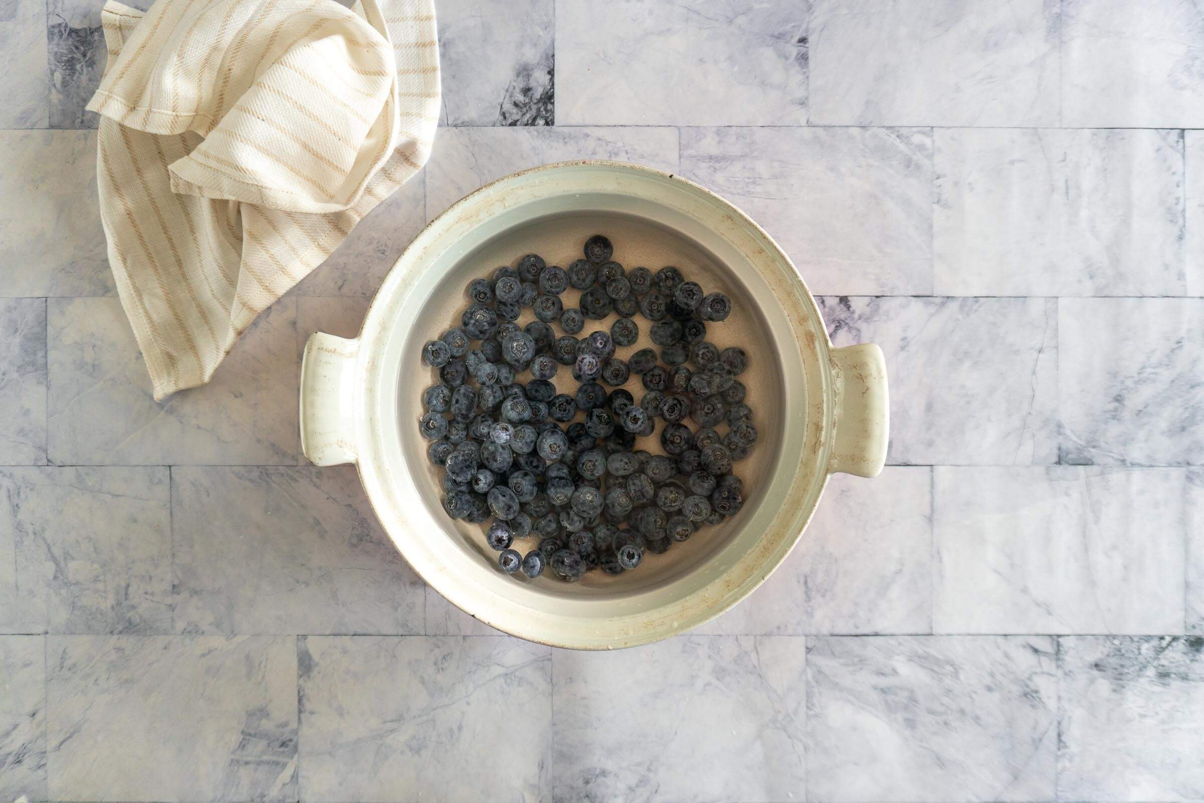Checking Fresh blueberries in a pot of boiling water.