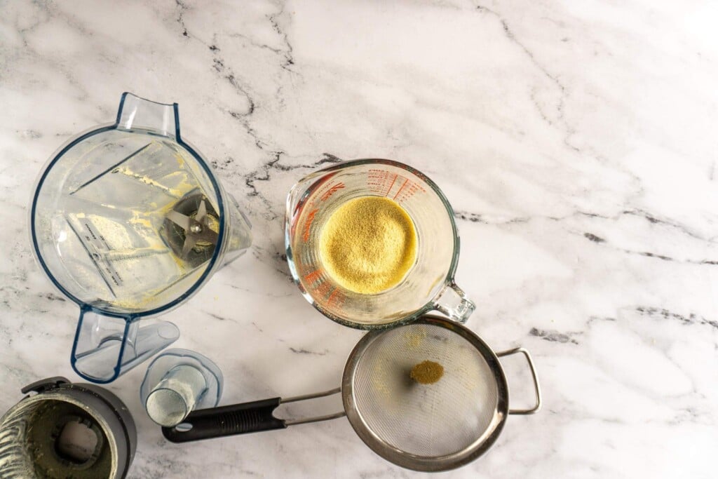 Sieved homemade ginger powder in measuring cup.
