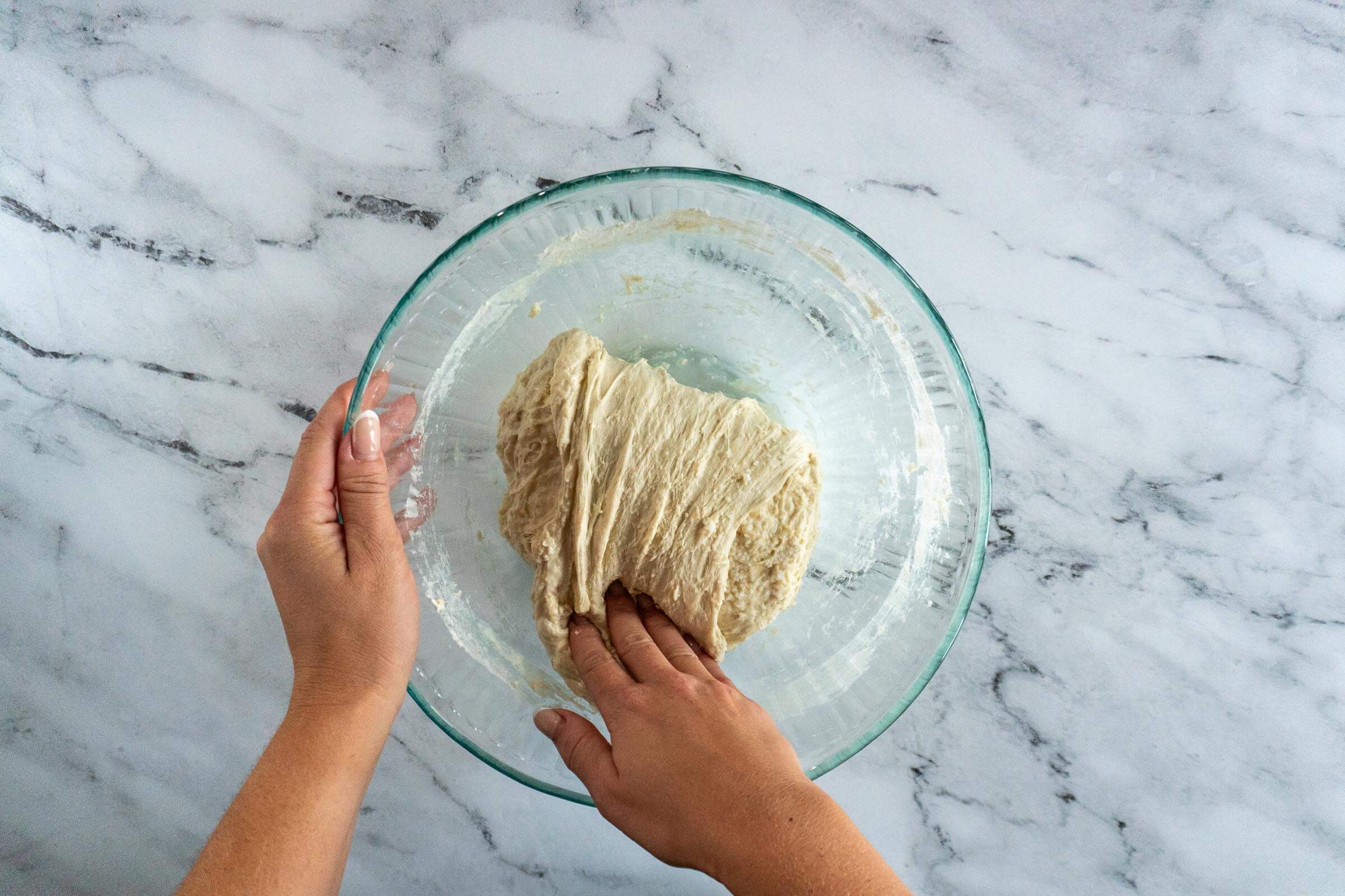 Folding the dough over itself.