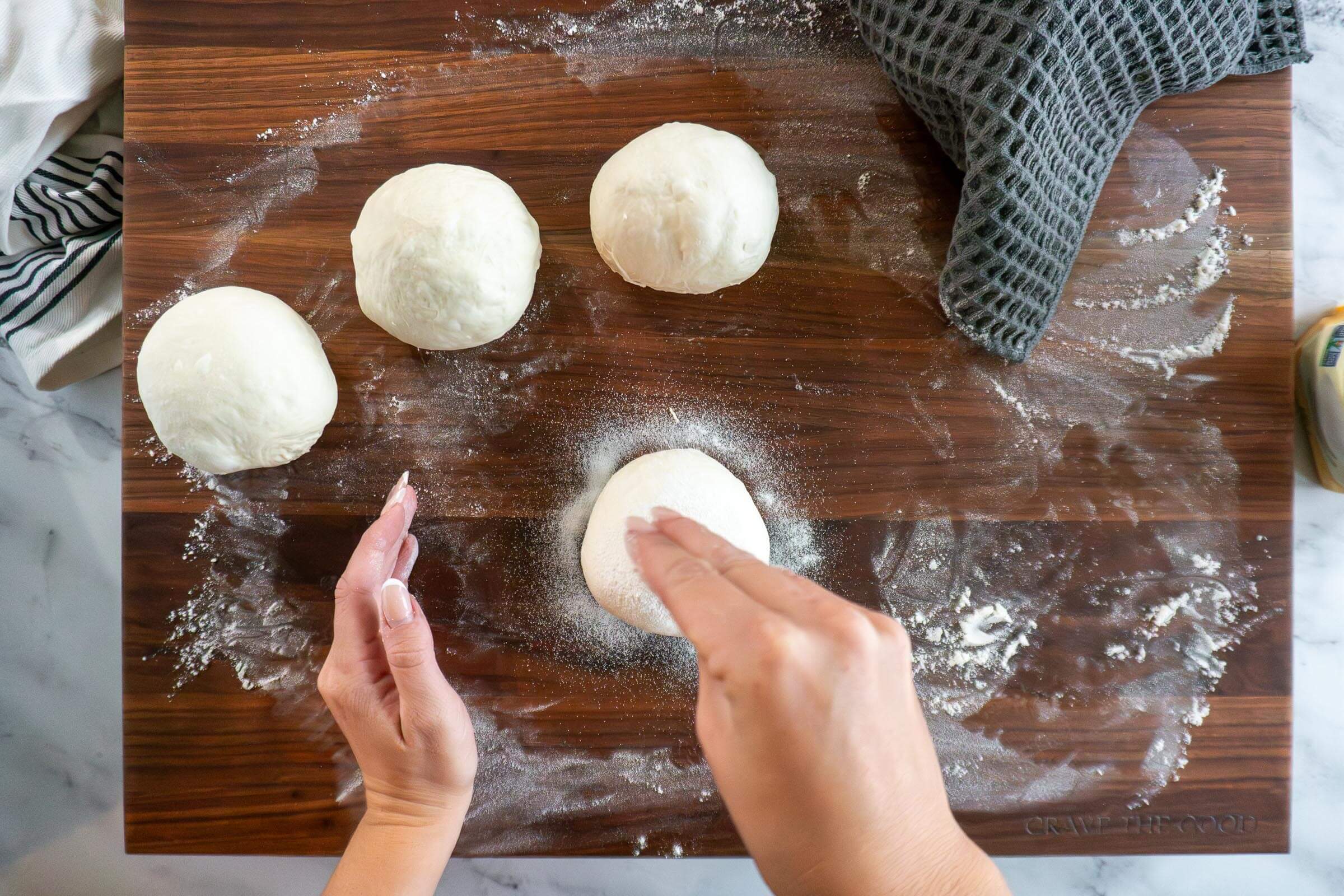 Sprinkling prepared sourdough bread bowl with rice flour.