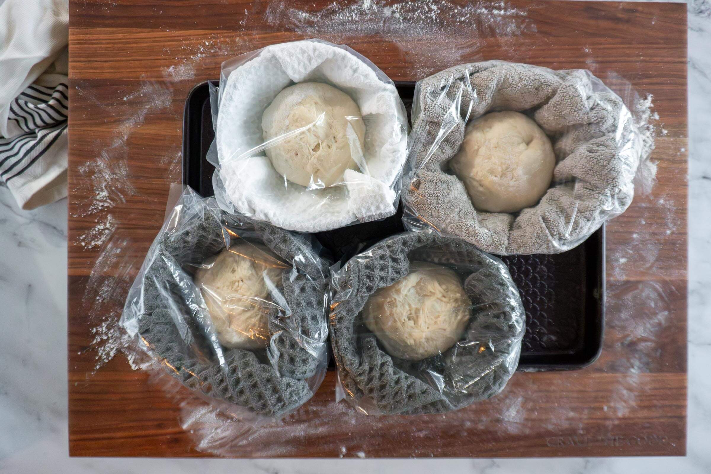 All 4 bread bowls in their own bowl wrapped in plastic.