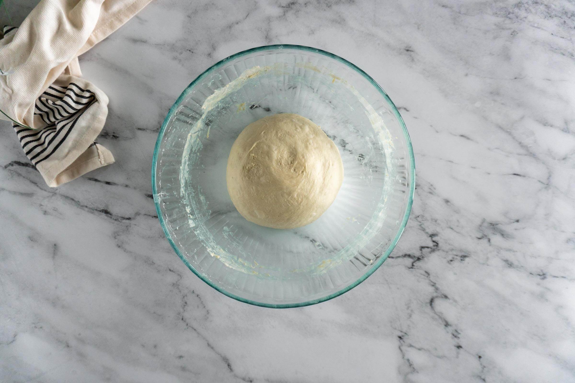 Sourdough bread bowl dough in a glass bowl before bulk ferment.