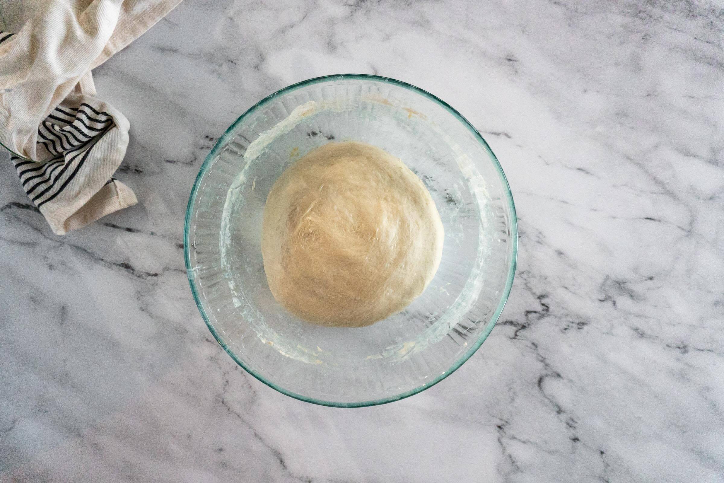 Bread bowl dough in glass bowl after bulk ferment.