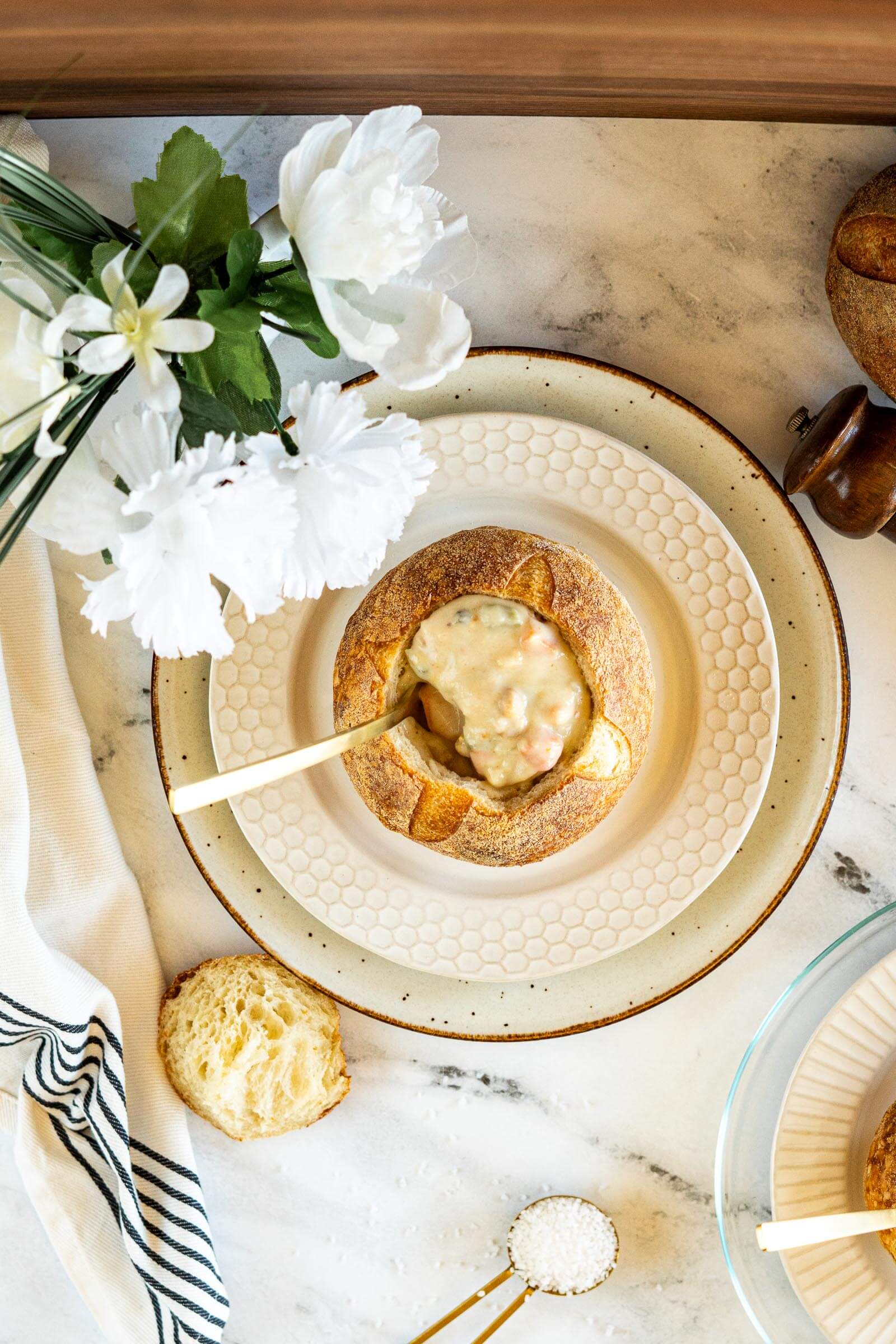 Sourdough bread bowl filled with creamy potato and bacon soup.