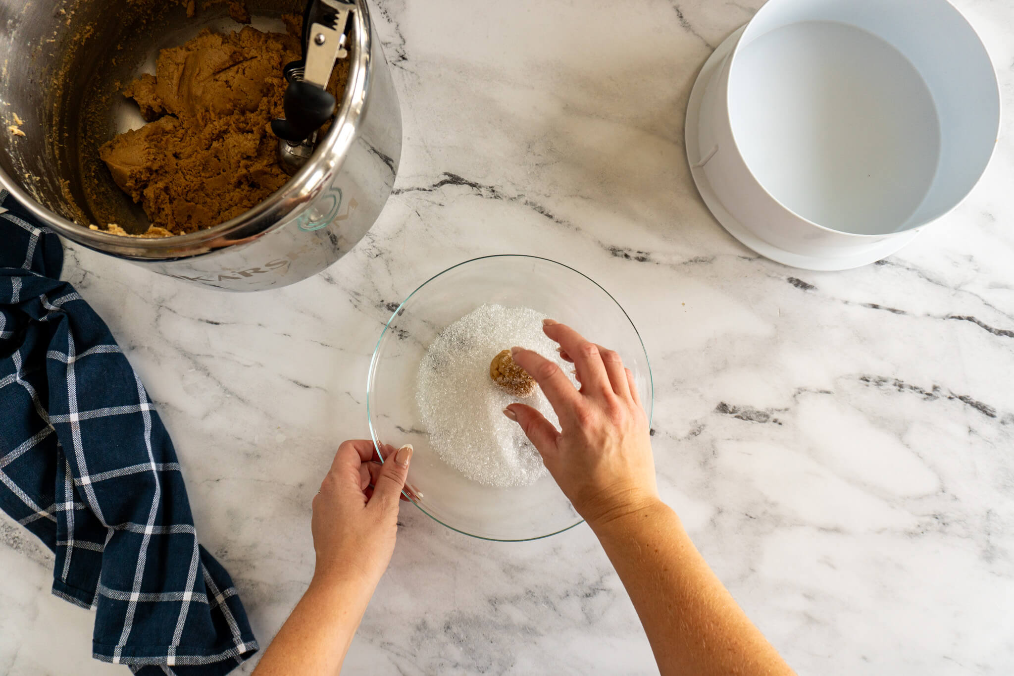 Rolling dough ball in sanding sugar. 