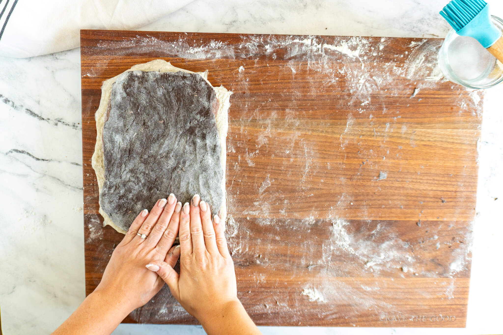 Pressing dark cocoa sourdough into the previous layers. 