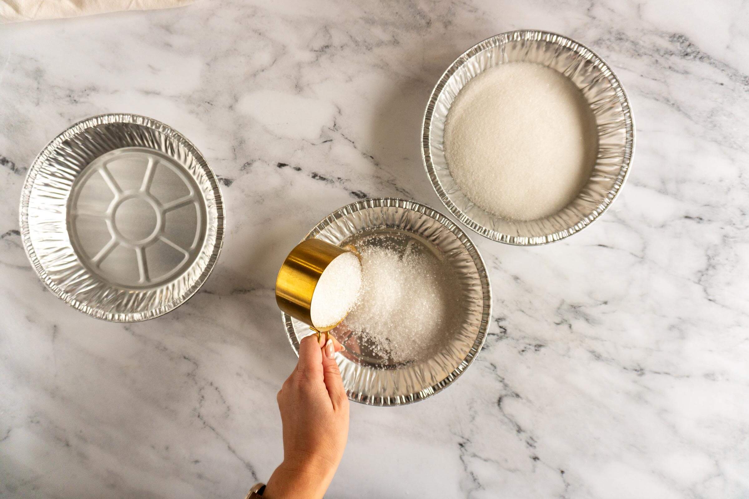 Adding decorative sugar to a pie plate. 