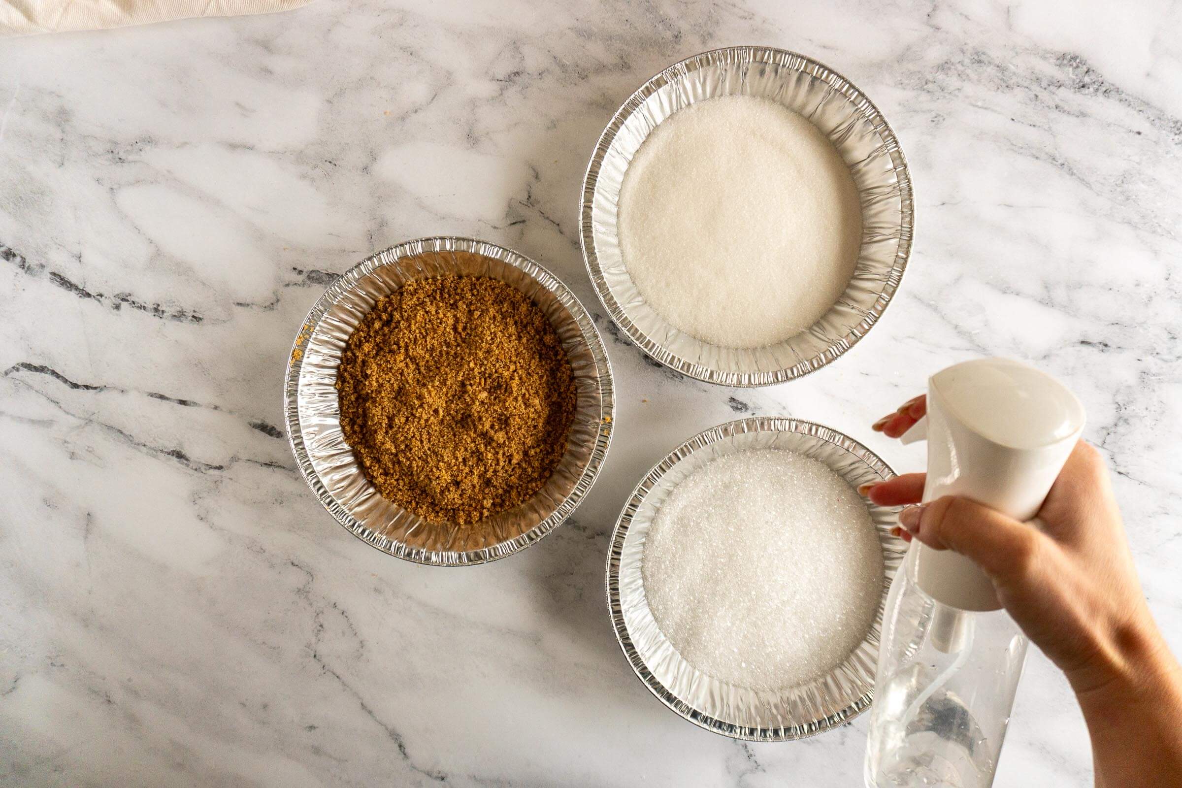 Spritzing sugar with water. 