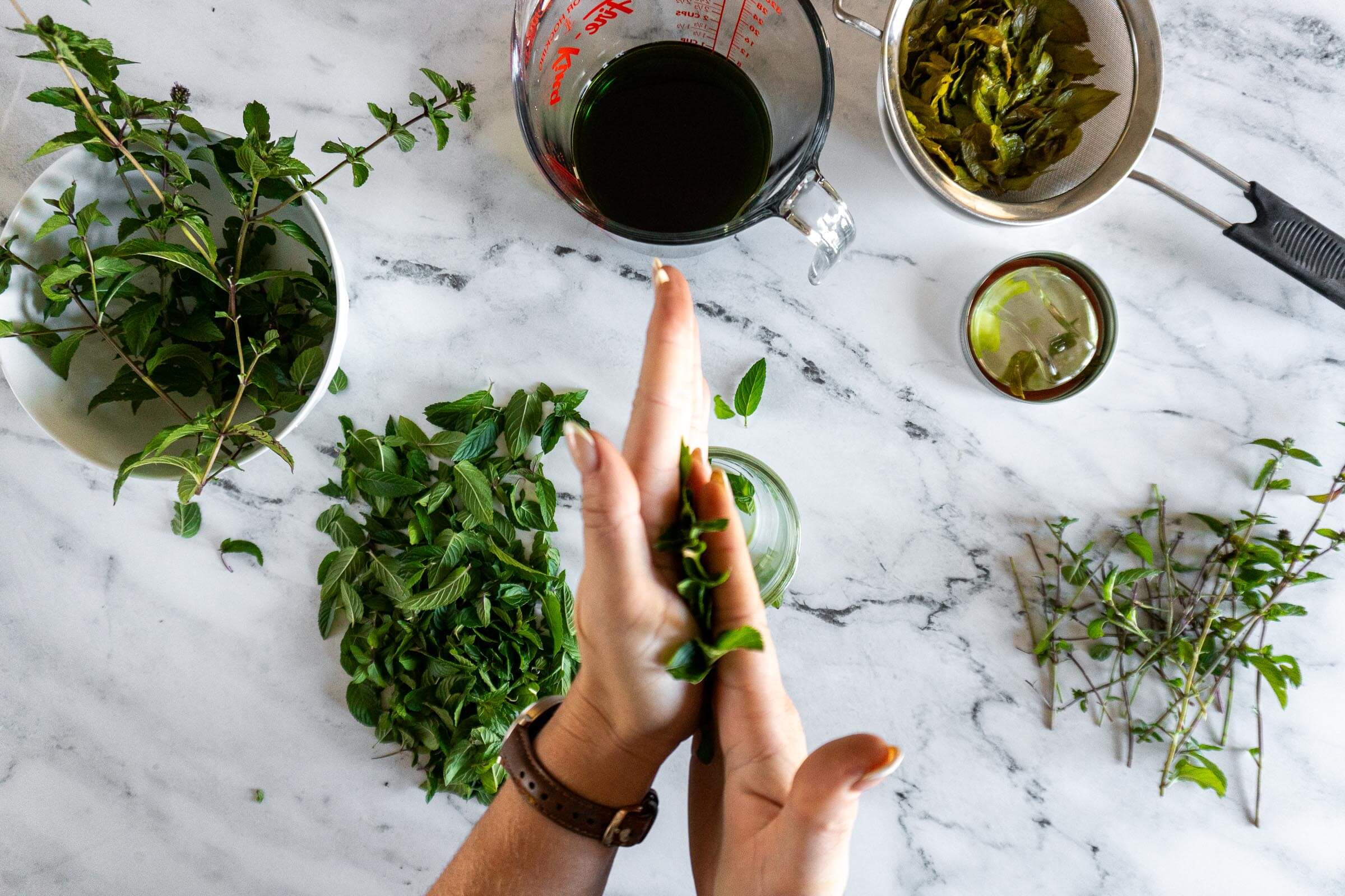 Muddling leavs by rubbing between palms.