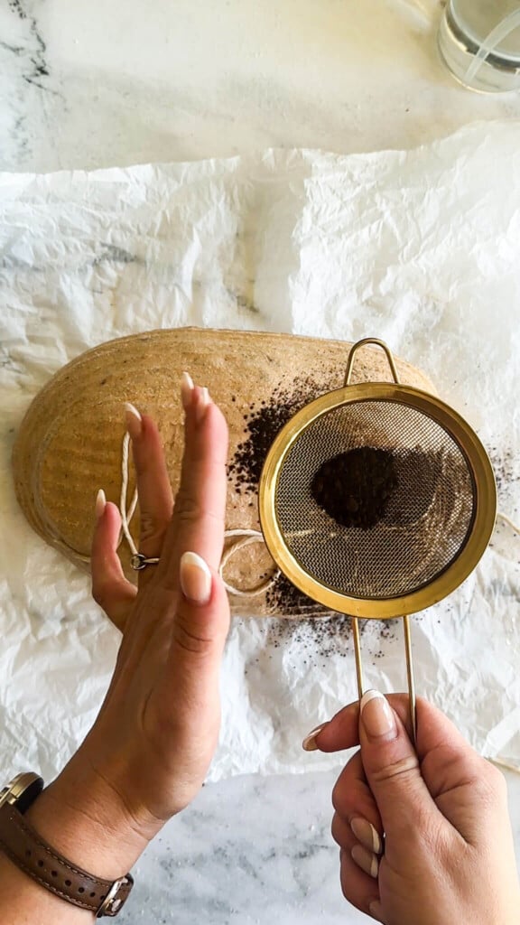 Dusting the loaf with black cocoa powder.