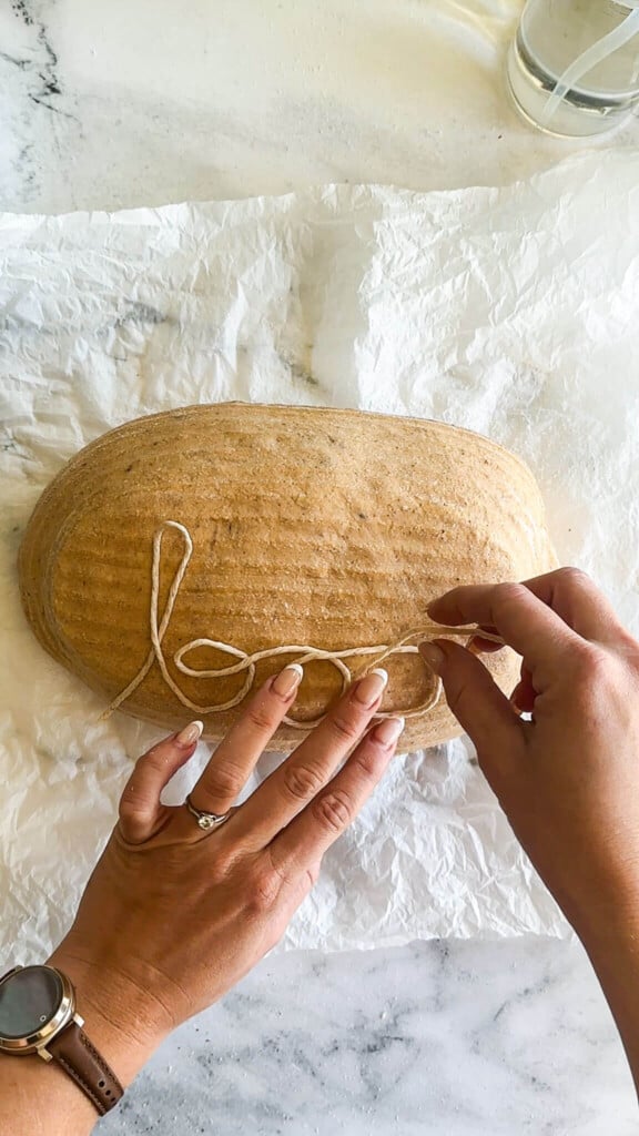 Spelling the word boo with twine.