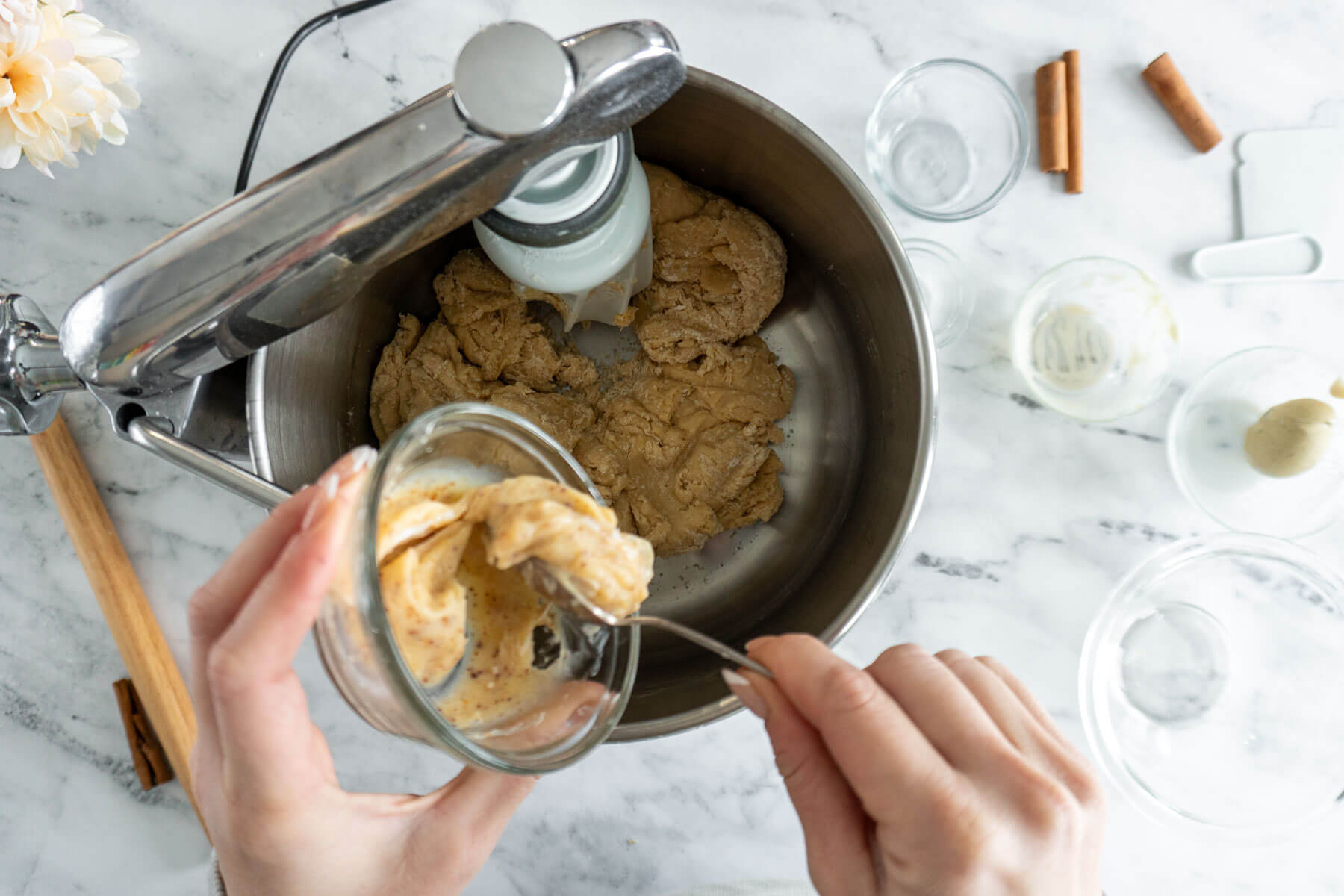 Adding browned butter to dough. 