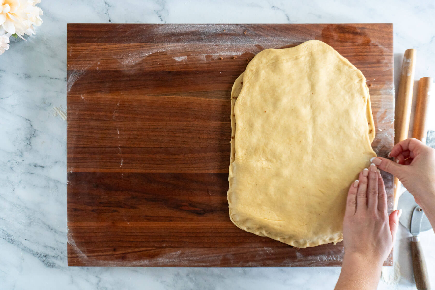 Pressing the seam of the dough closed. 