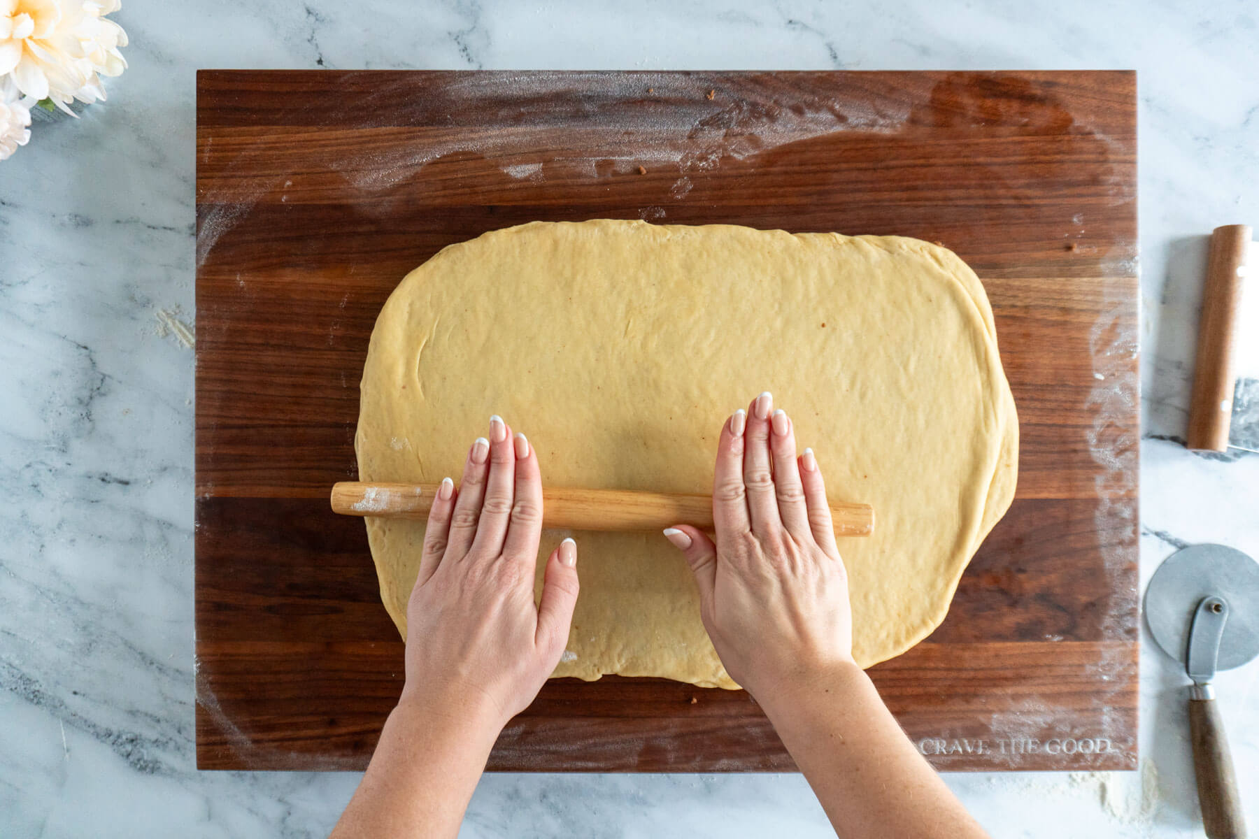 Rolling the dough once more. 