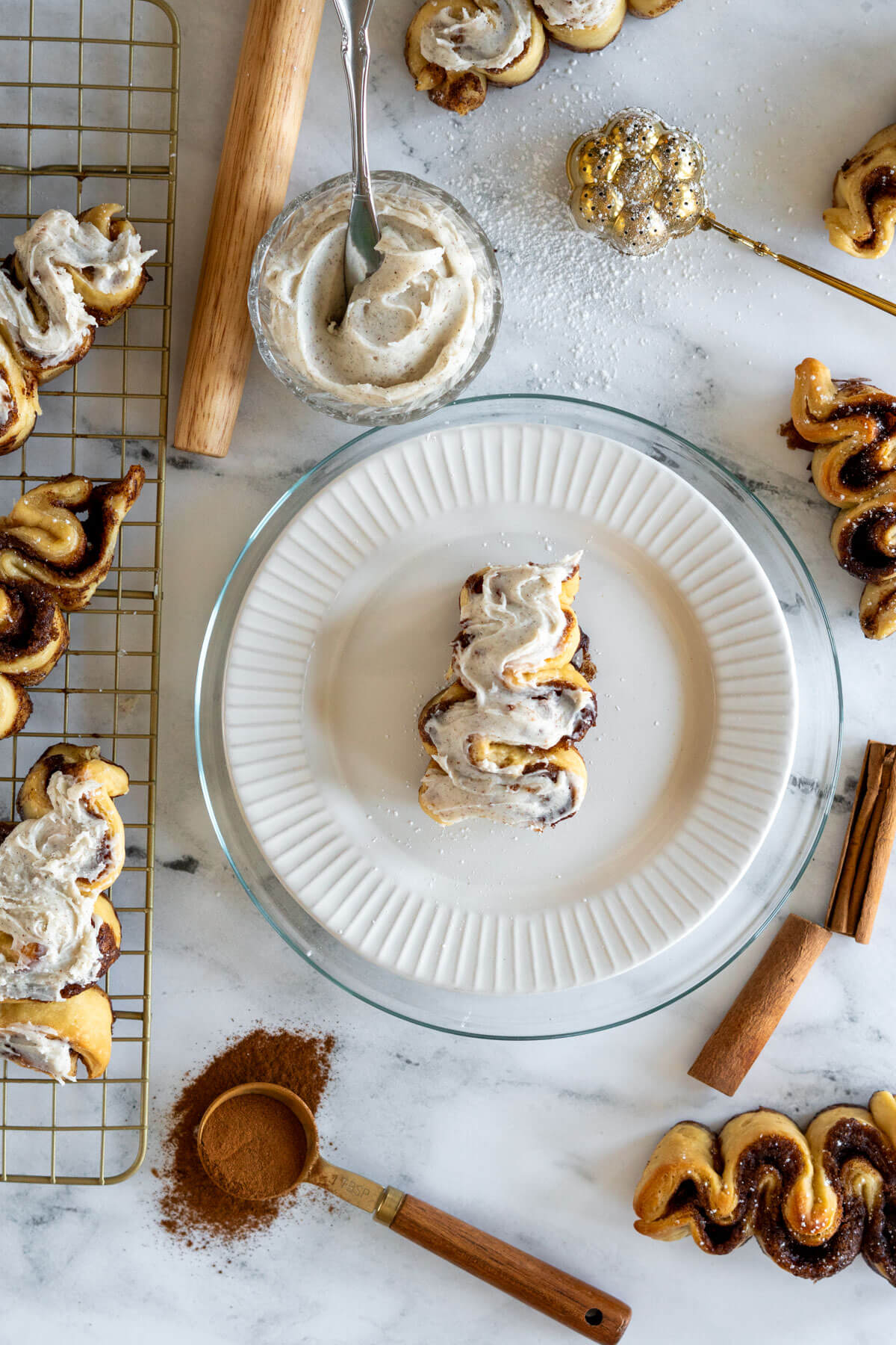 Iced cinnamon roll Christmas tree on a white plate.