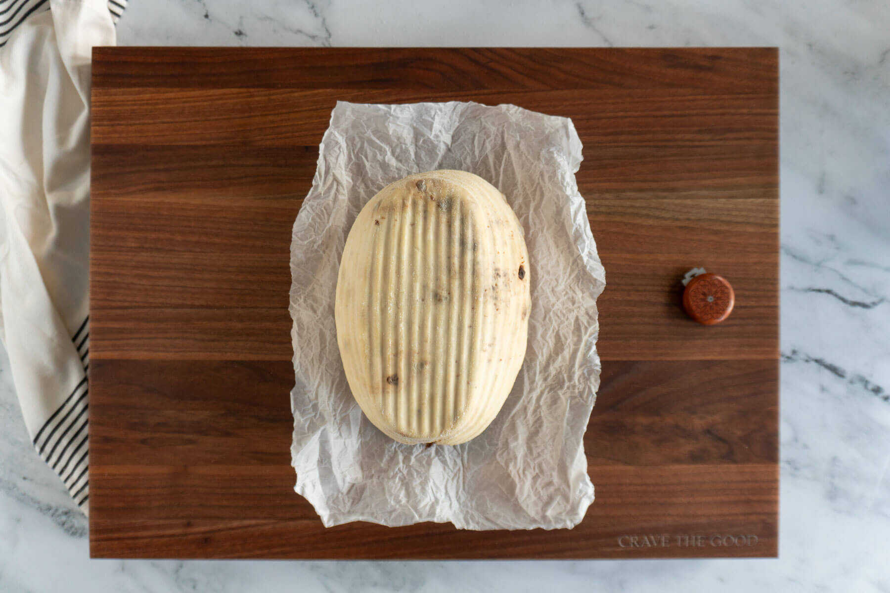 Sourdough loaf inverted on parchment paper. 