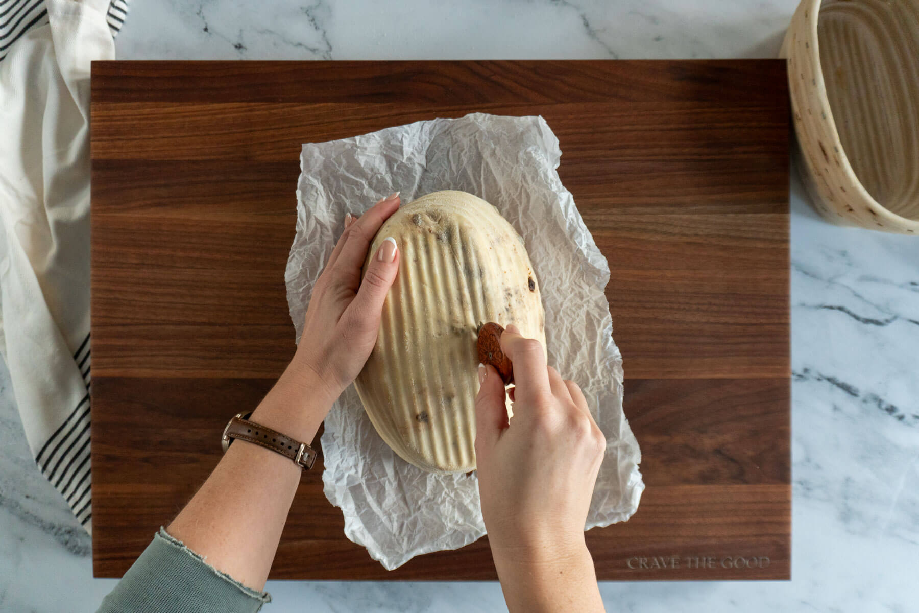 Scoring sourdough loaf with a UFO lame. 