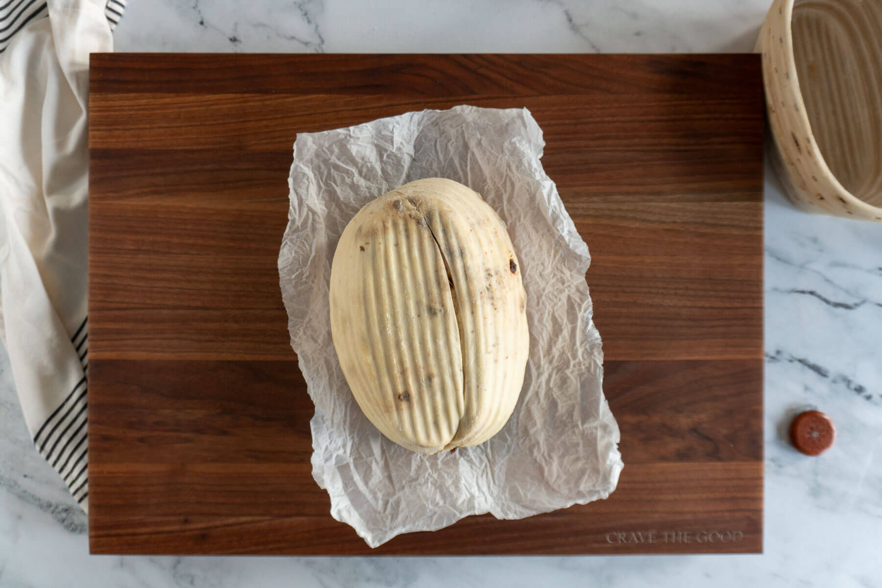 Scored sourdough loaf ready for baking. 
