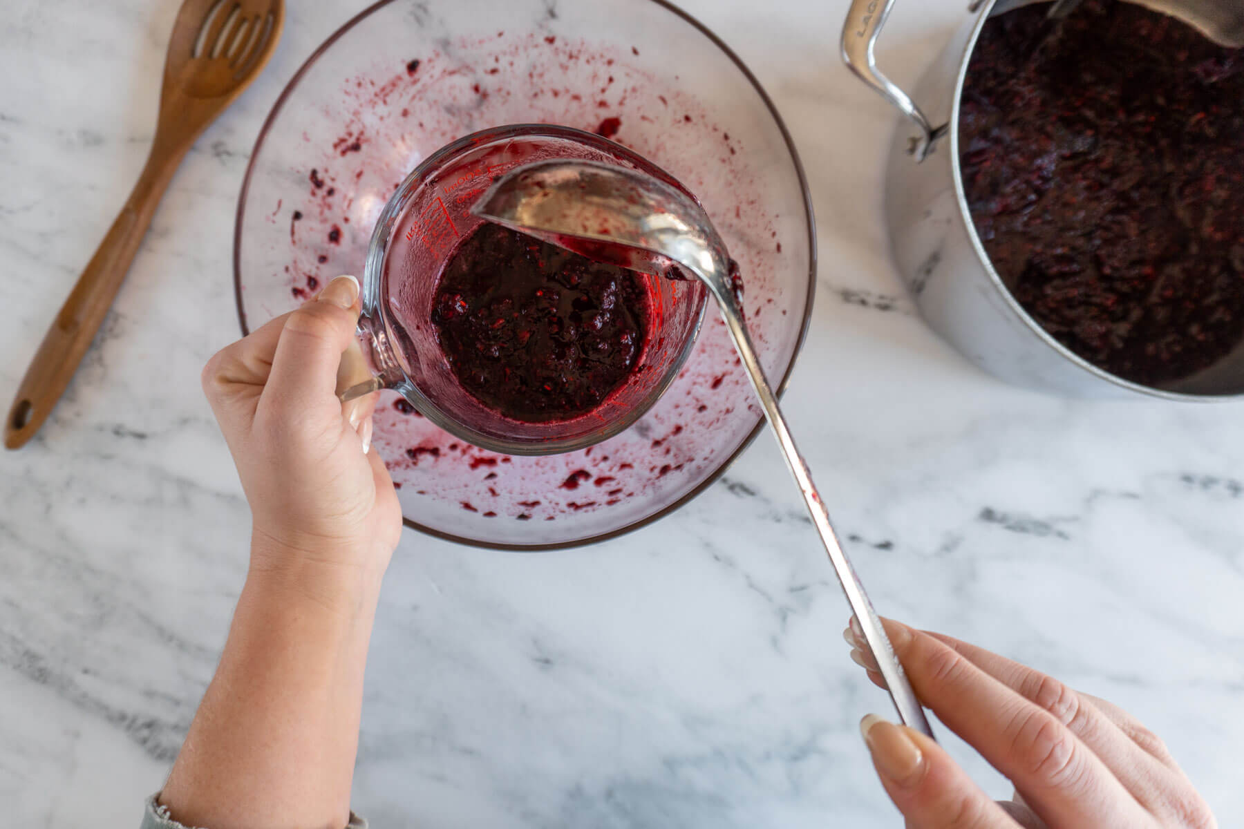 Measuring mashed blackberries.
