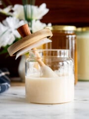 Homemade creamed honey in a glass jar.