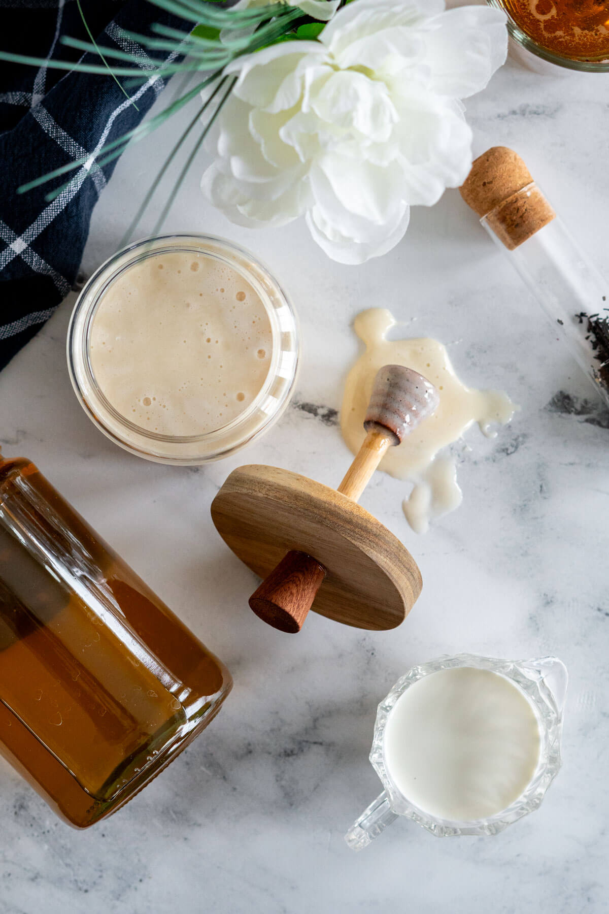 Creamed honey beside a jar of liquid honey.