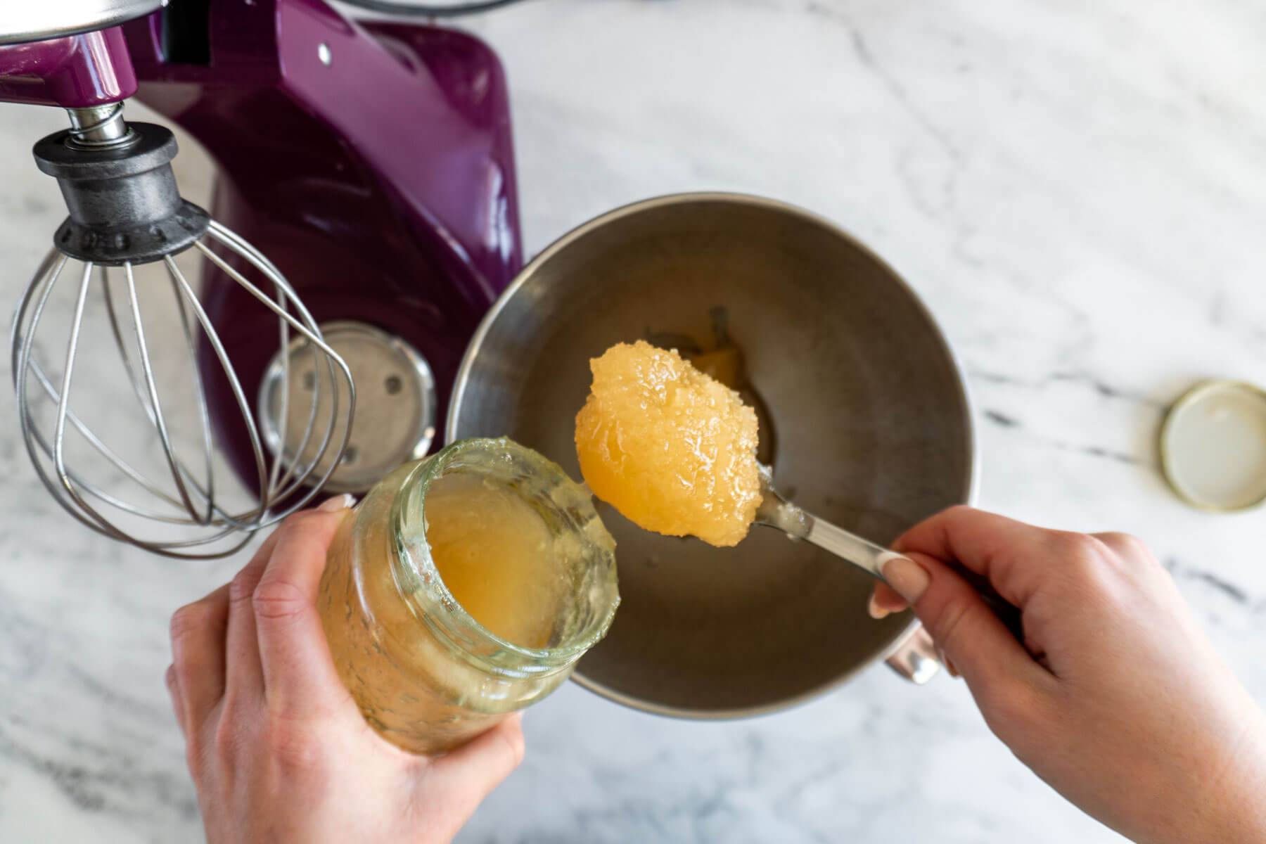 Adding crystallized honey to the mixer. 