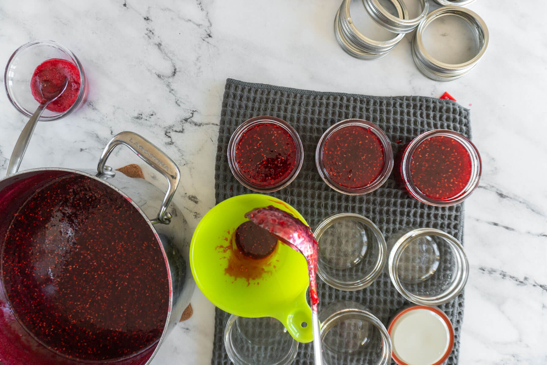 Ladleing jam into prepared mason jars. 