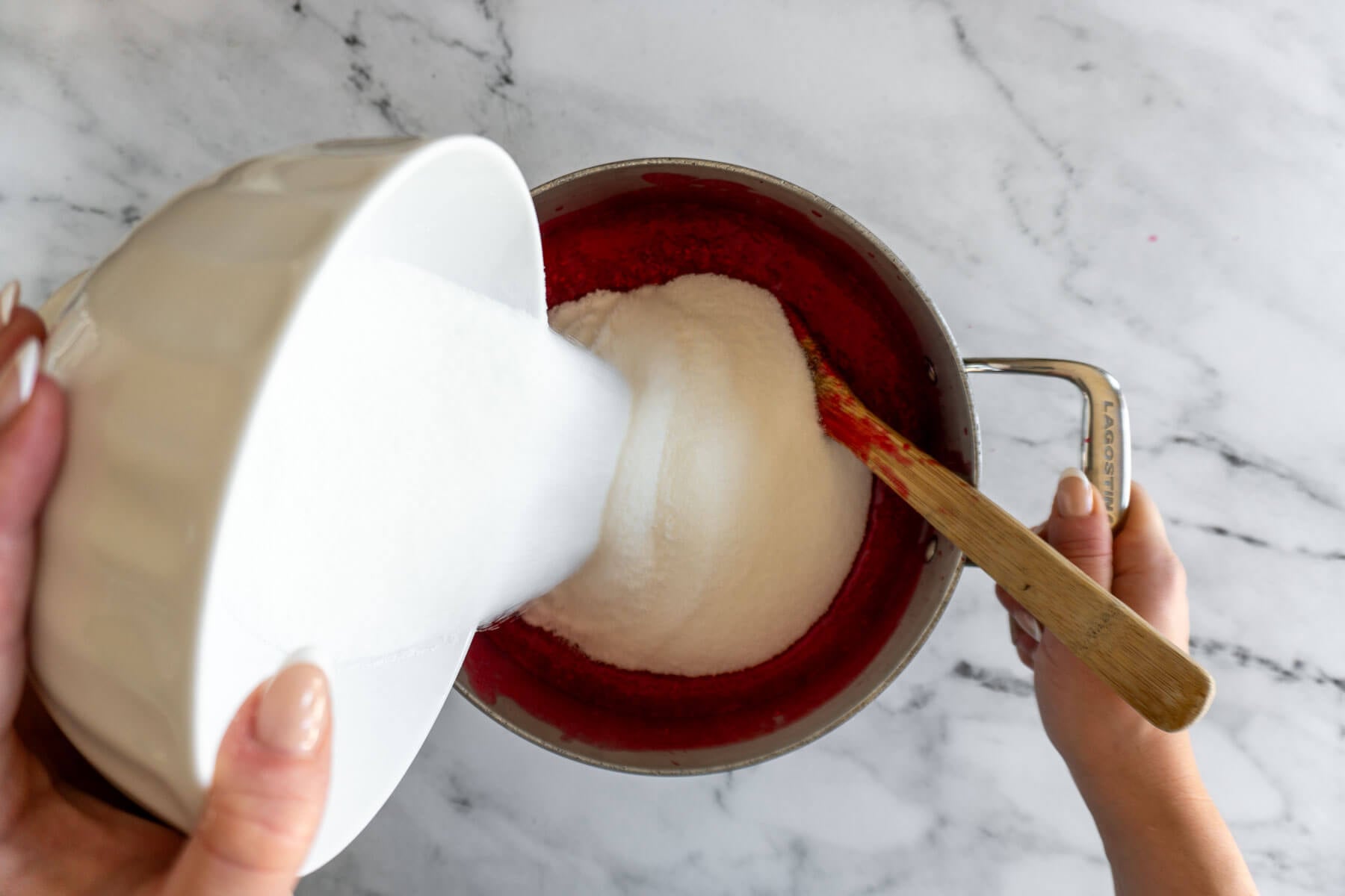 Adding sugar once berries come to a boil. 