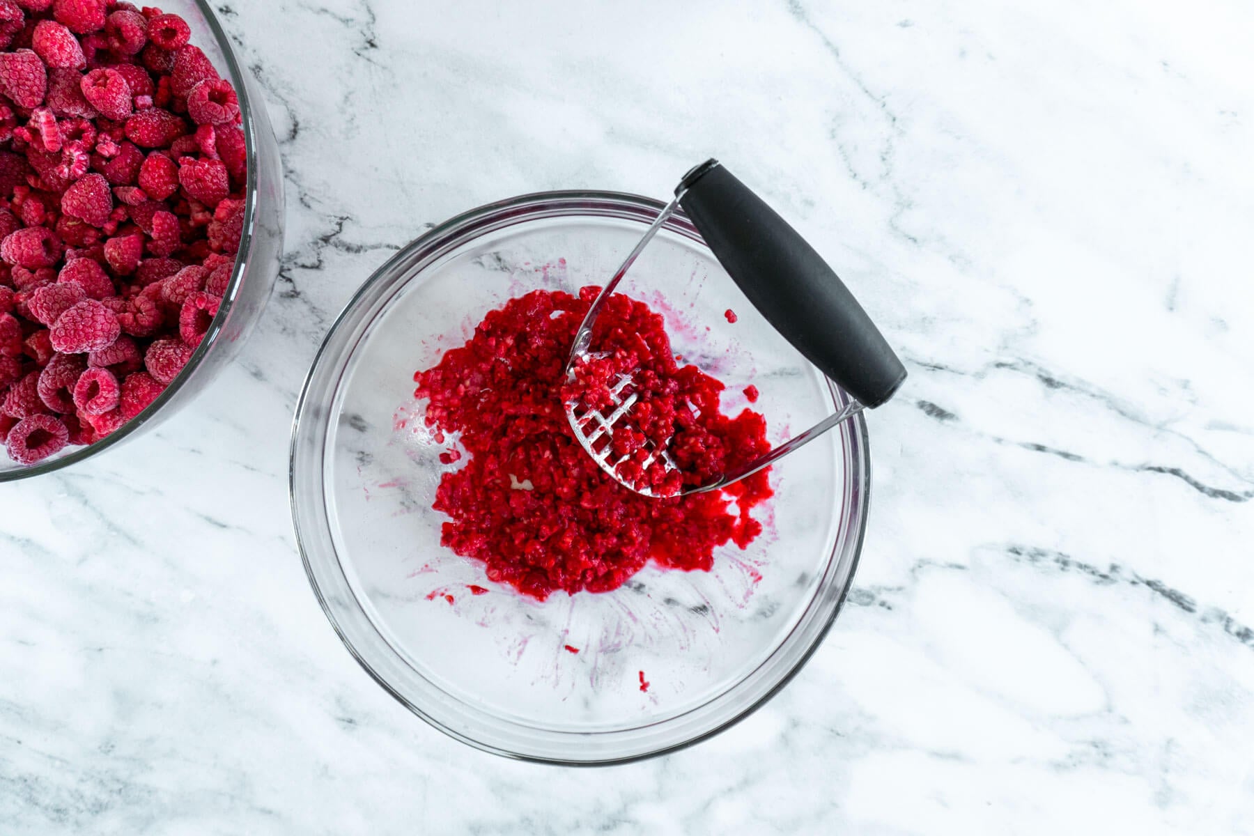 A single layer of berries, mashed in a large bowl. 