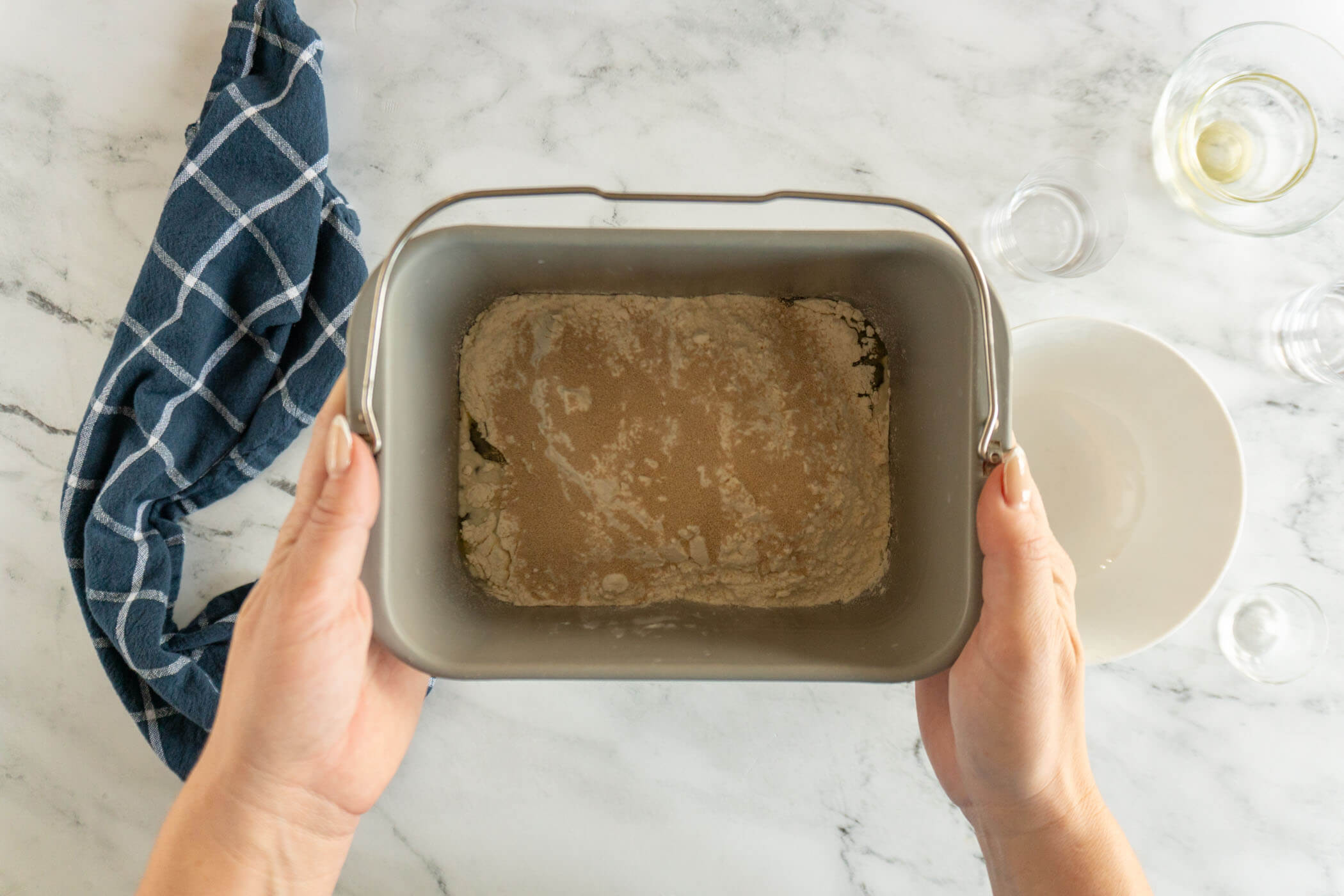 Bread pan before bread machine mixes and proofs the dough. 