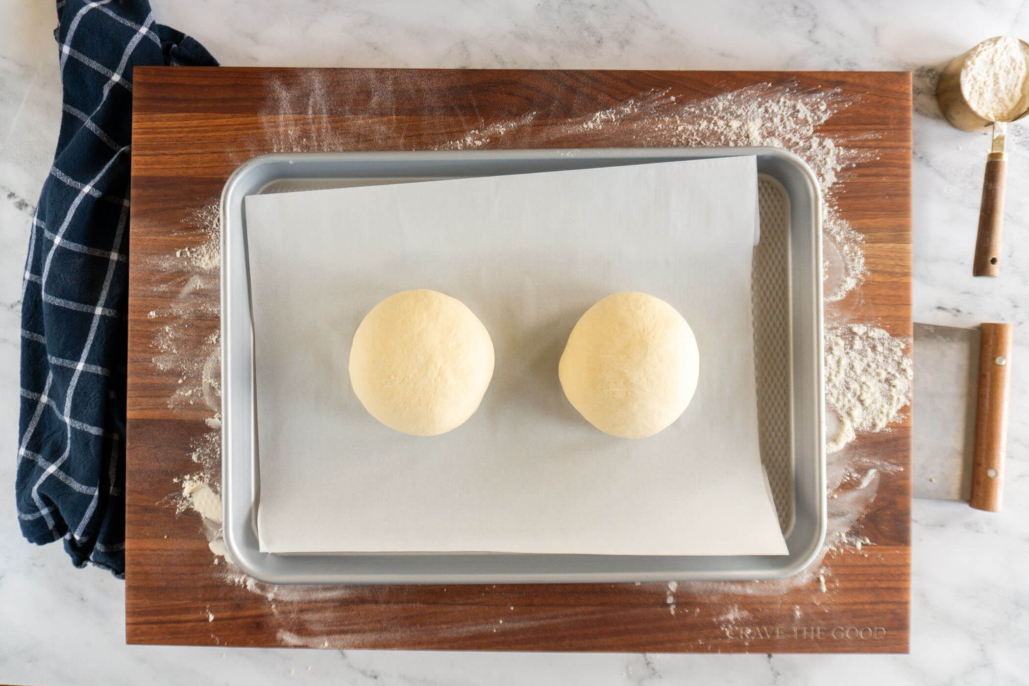 Shaped dough balls on a prepared baking sheet. 