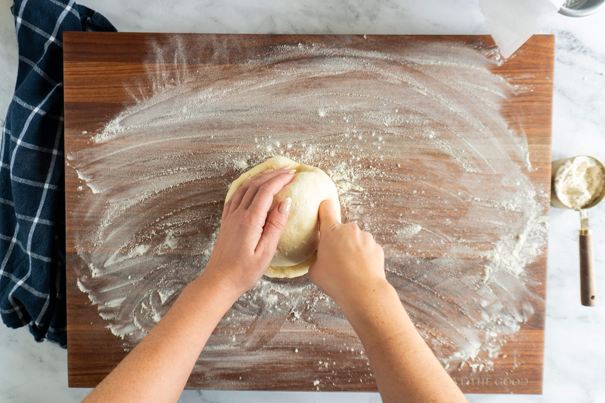 Pressing in the edges of the pizza dough. 