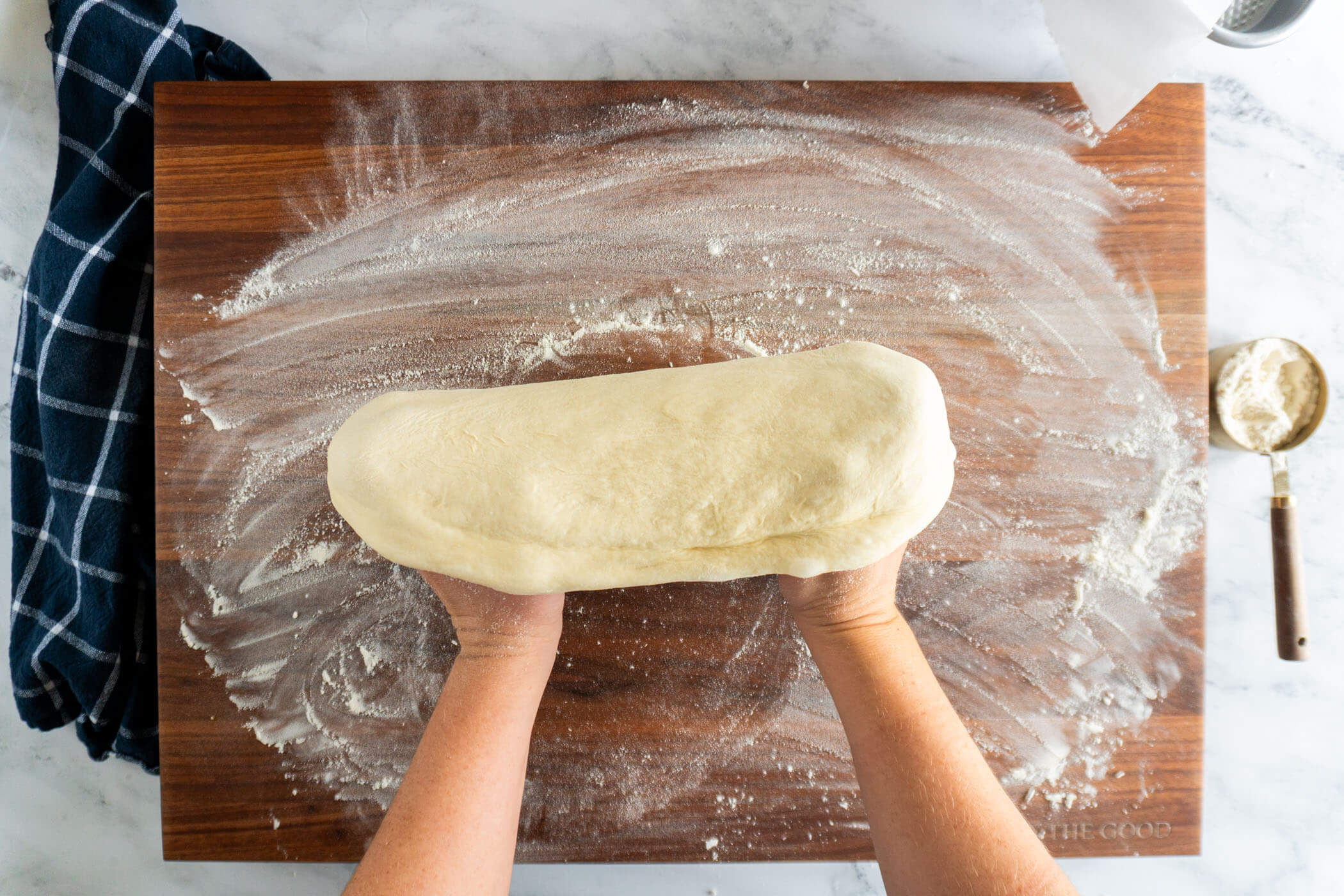 Fists underneath the dough.