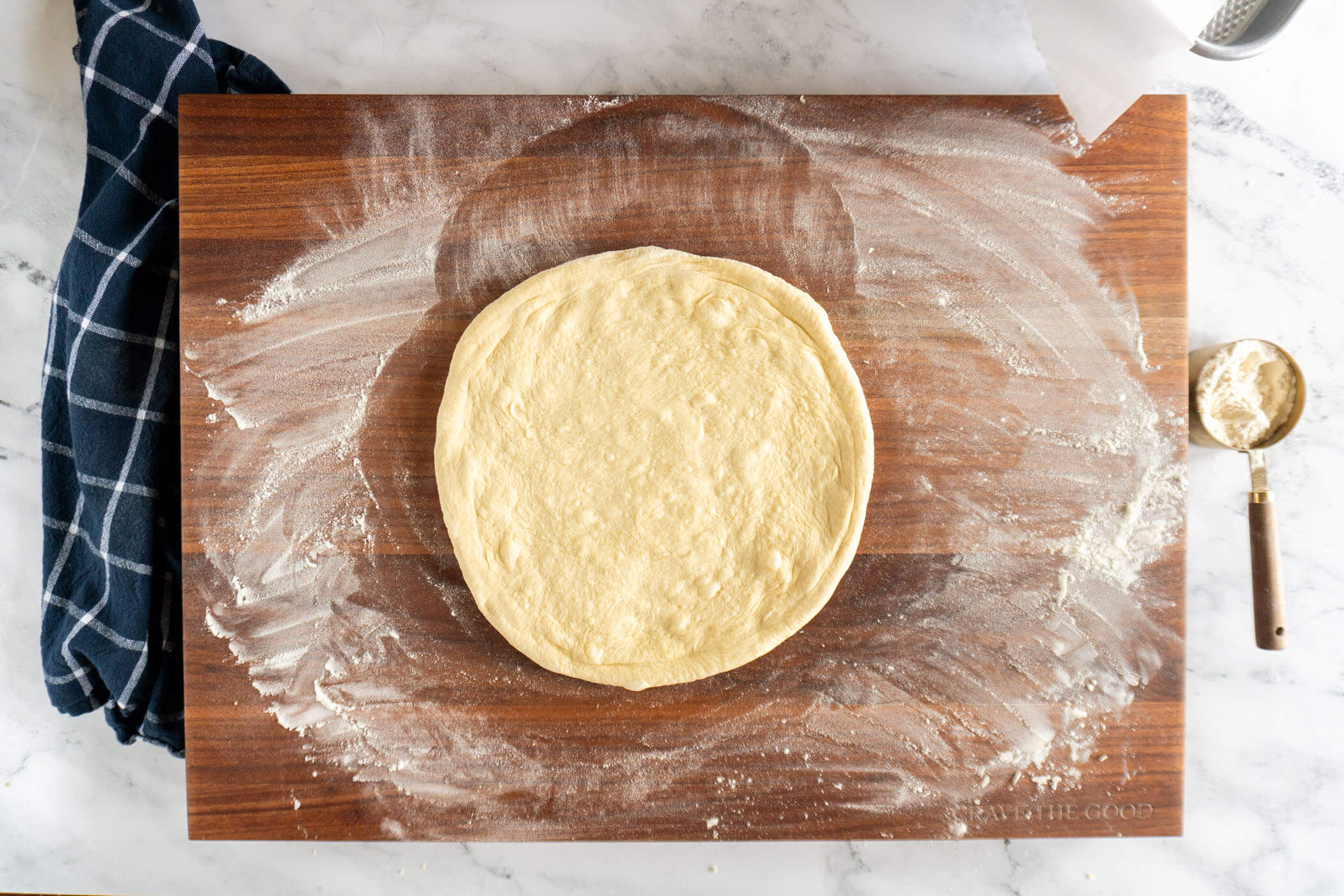 Pizza crust fully hand shaped. 