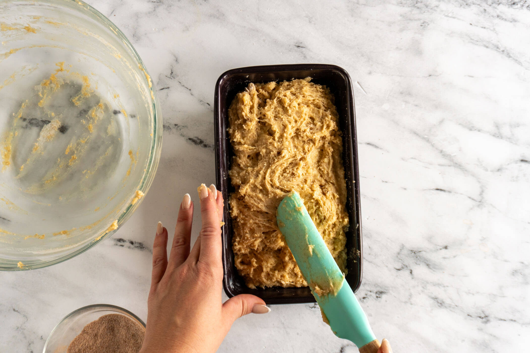 Spreading the rest of the batter on top of the loaf. 
