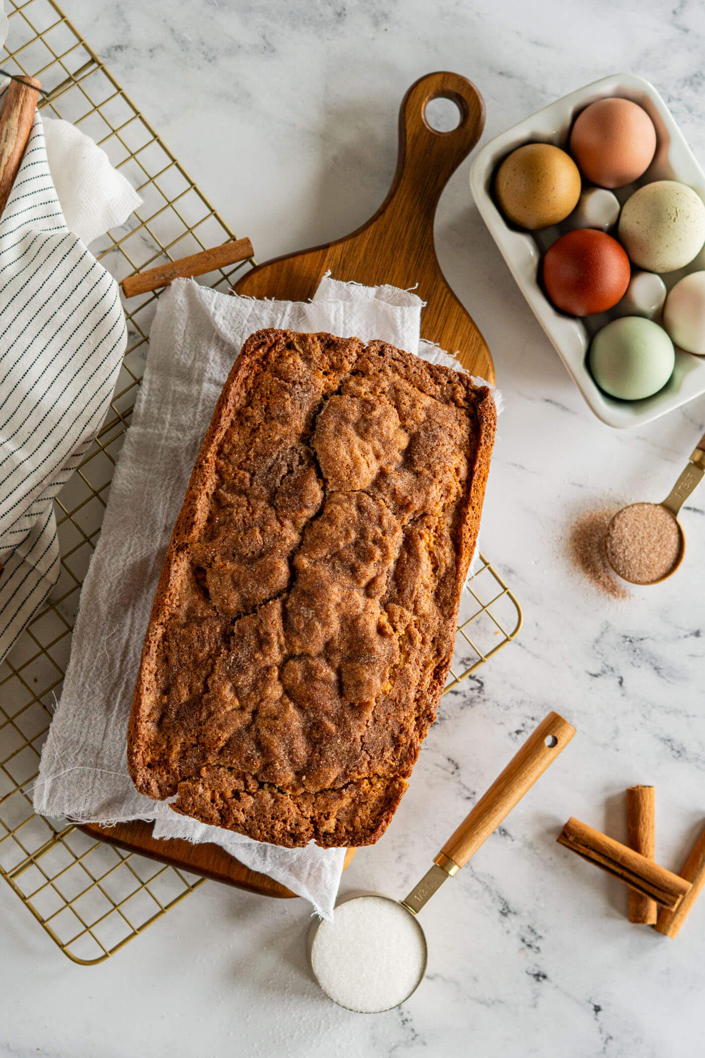 Loaf of sourdough discard cinnamon quick bread on a cutting board. 