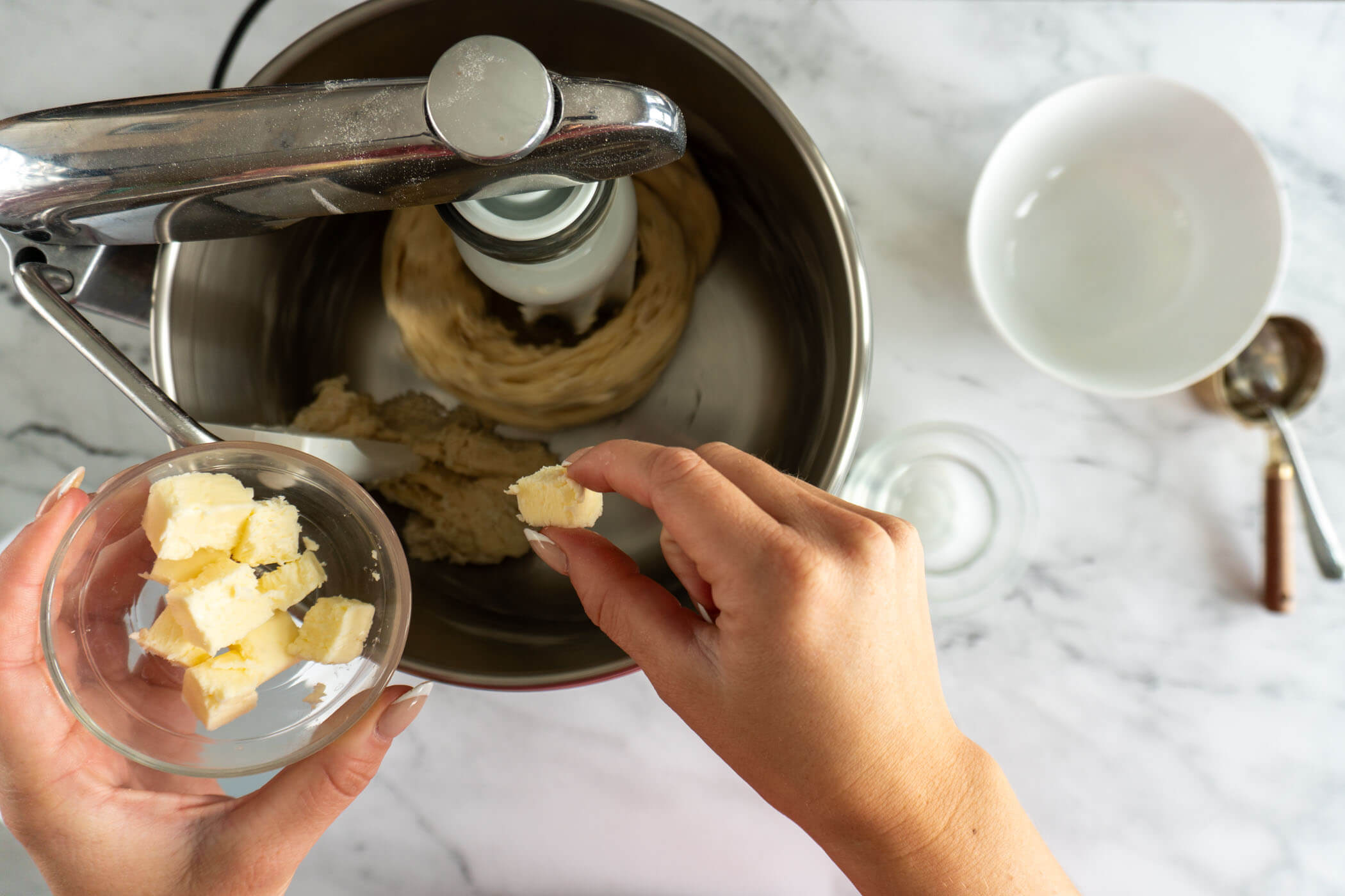 Adding butter to stand mixer. 