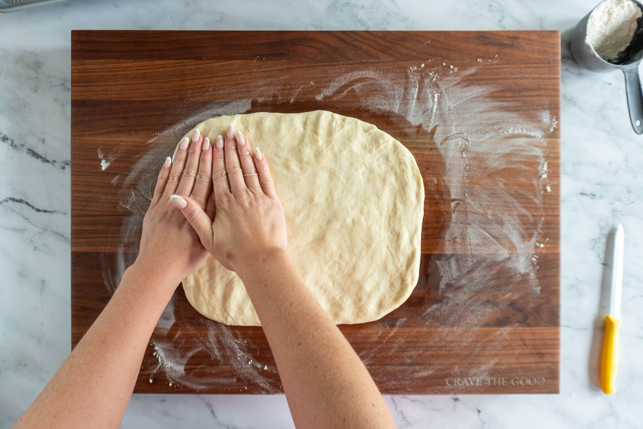 Pressing the dough into a rectangle. 