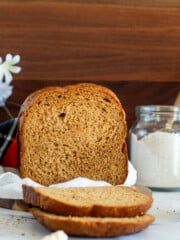 Baked and sliced bread machine rye on a white towel.