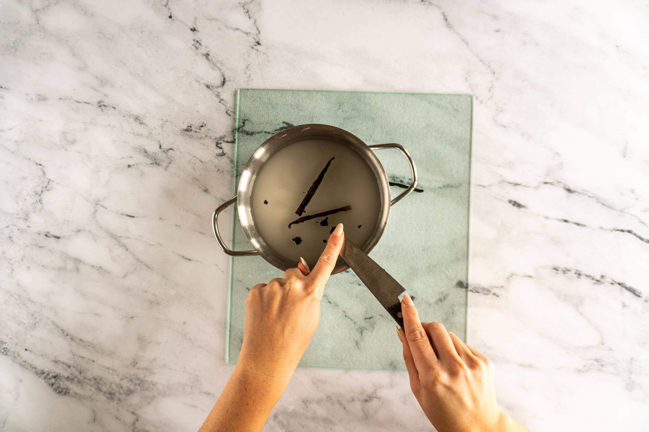 Adding seeds to sauce pan. 