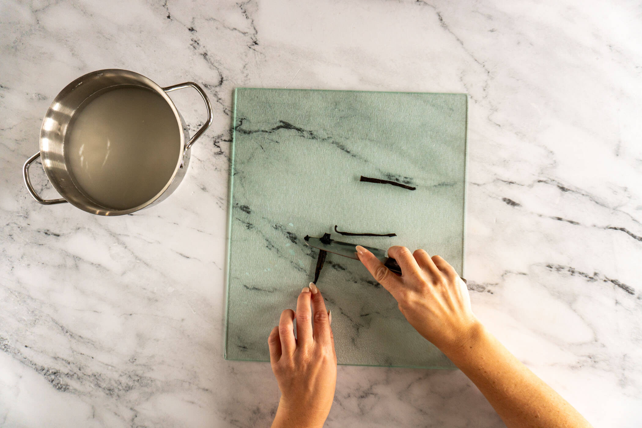 Scraping the vanilla pod to remove the seeds. 