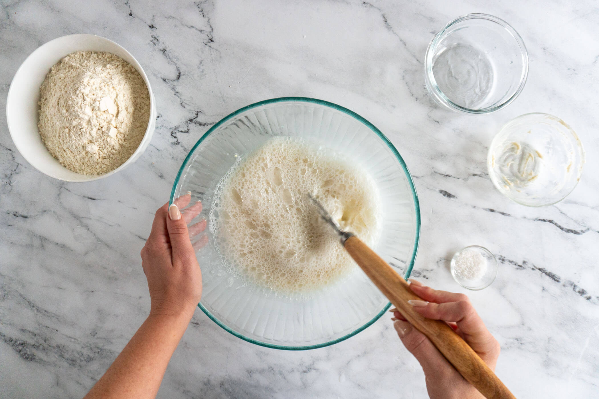 Whisking sourdough starter into the water.