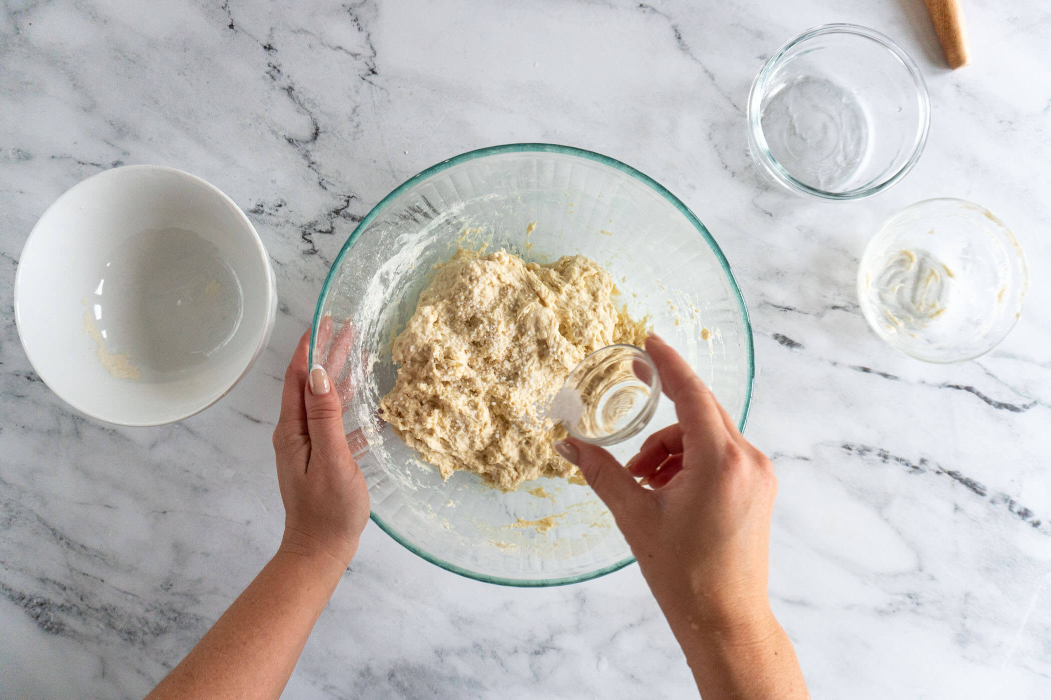 Sprinkling salt on top of the dough.