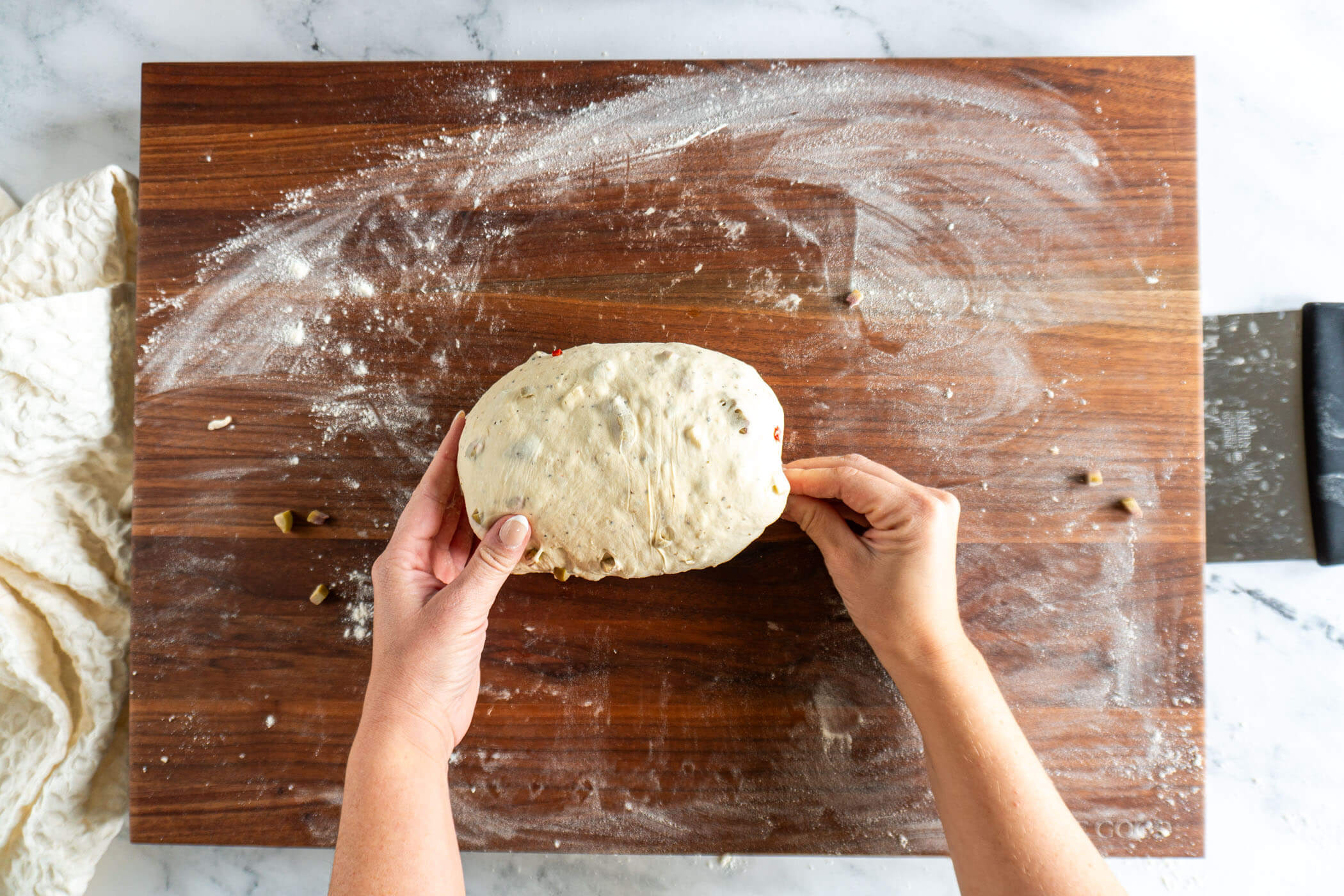 Pinching the ends of the batard closed.
