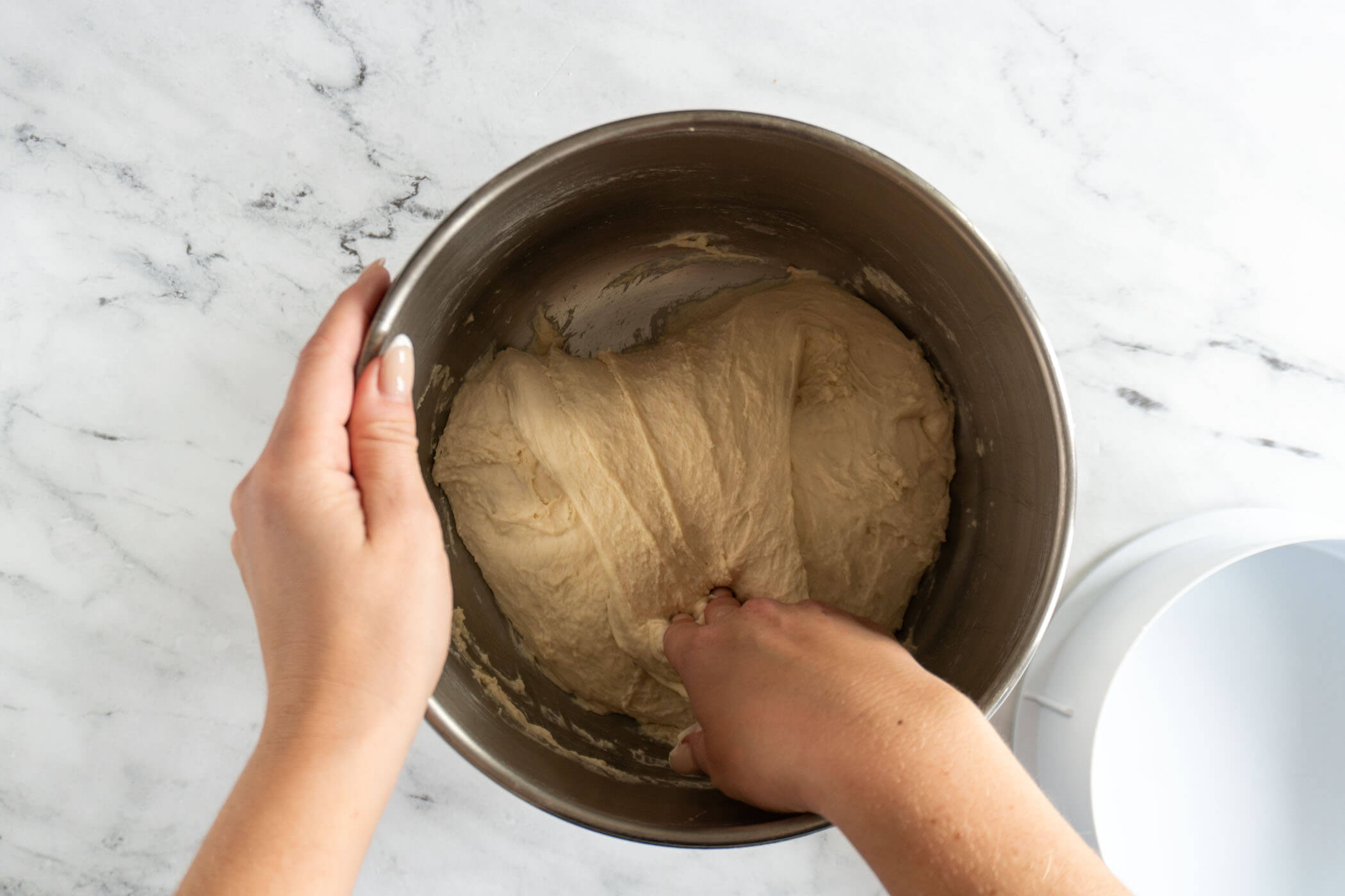 Folding the dough in the mixing bowl. 