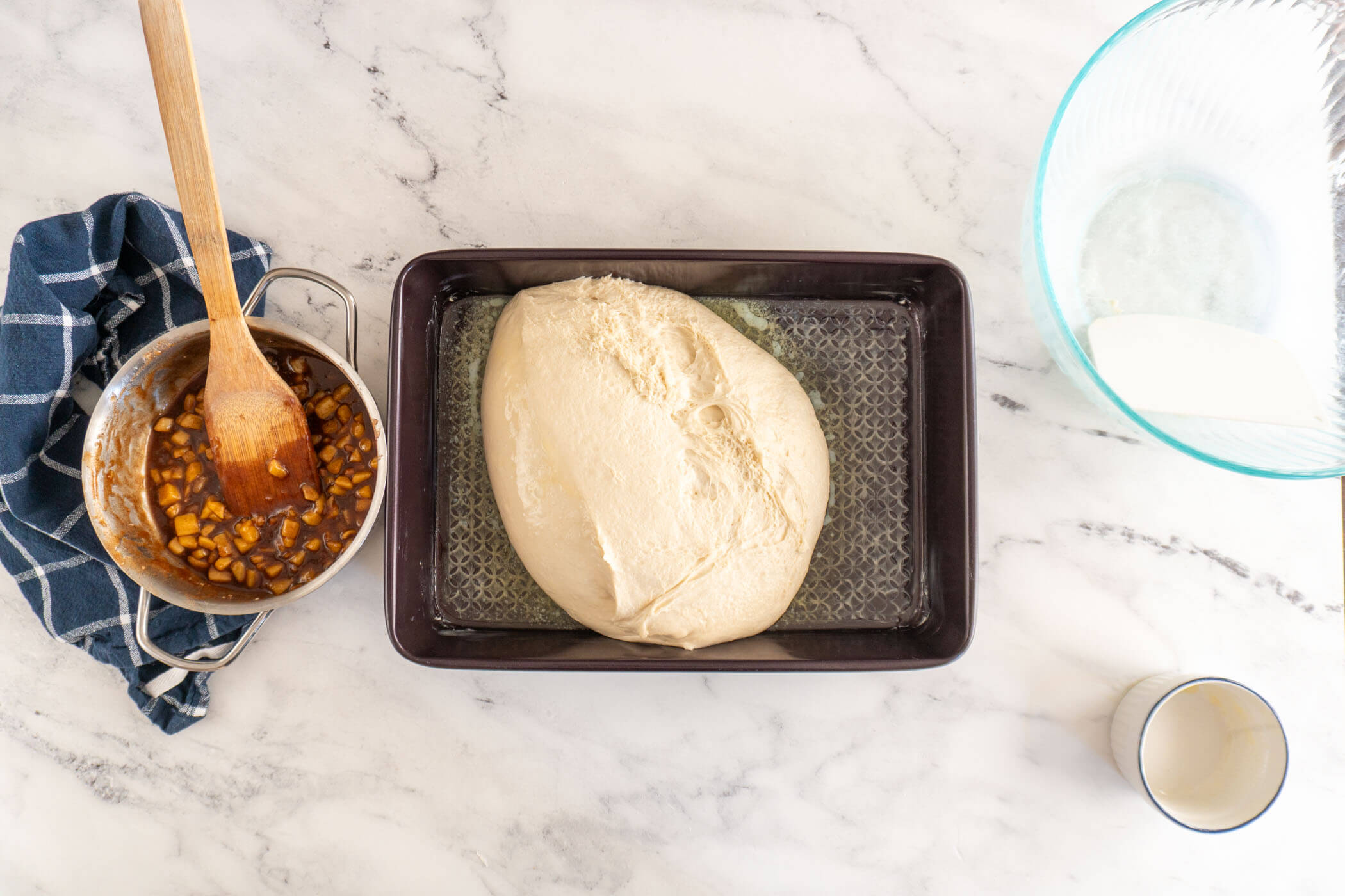 Proofed dough turned out into a greased and buttered pan. 