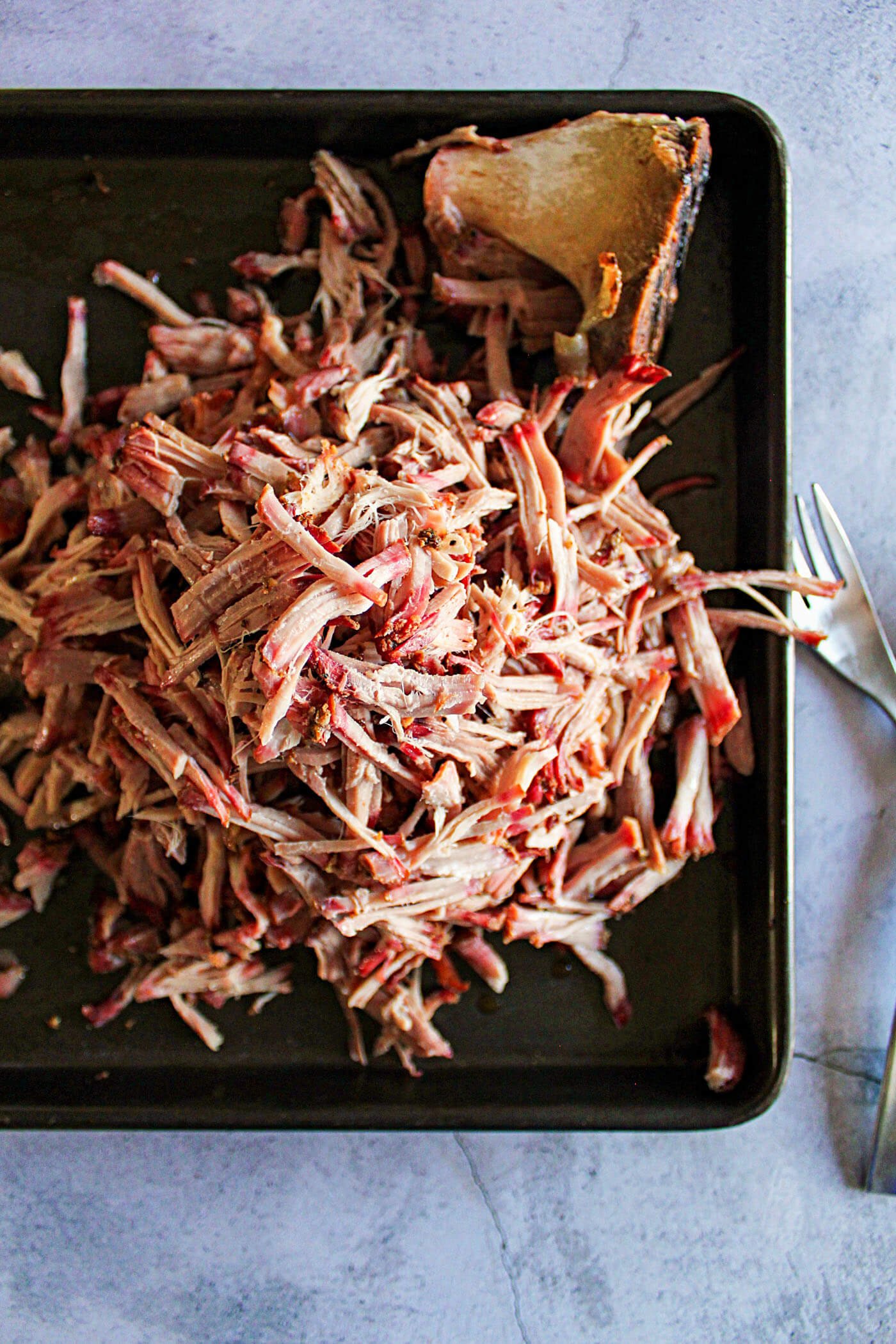 Fully shredded smoked pork picnic.