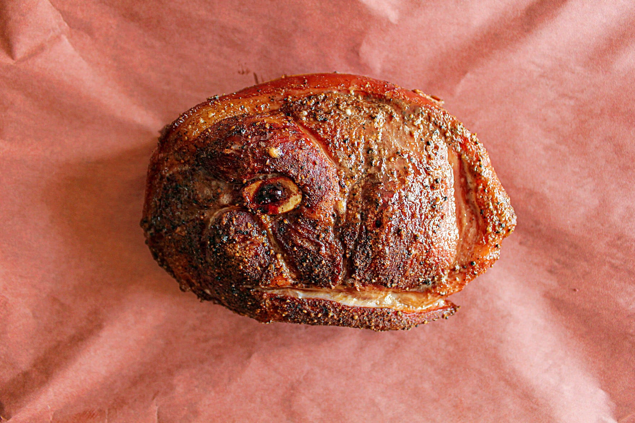 Pork picnic roast wrapped in butcher paper.